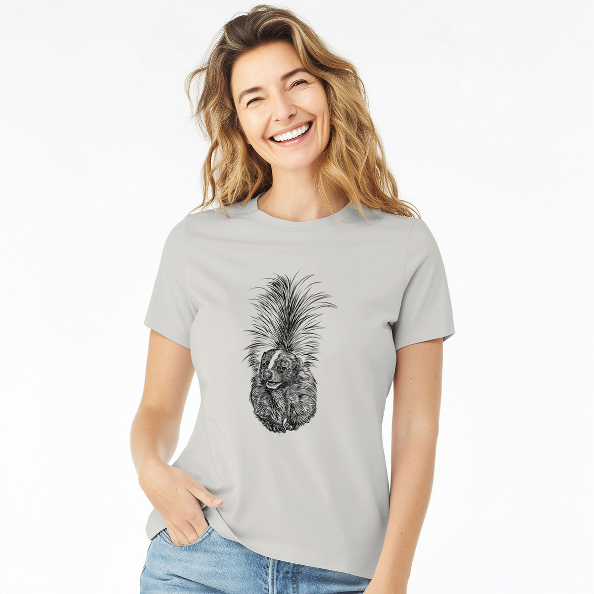 Woman wearing a lunar grey women's relaxed fit cotton t-shirt printed with a detailed black ink illustration of a striped skunk with its tail raised.