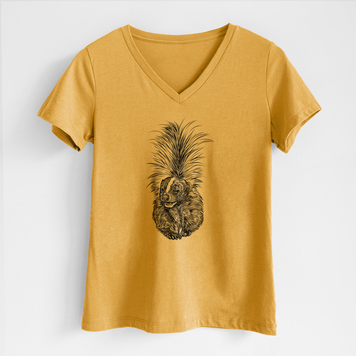 Honeycomb yellow women's relaxed fit cotton V-neck t-shirt laid flat, printed with a detailed black ink illustration of a striped skunk with its tail raised.