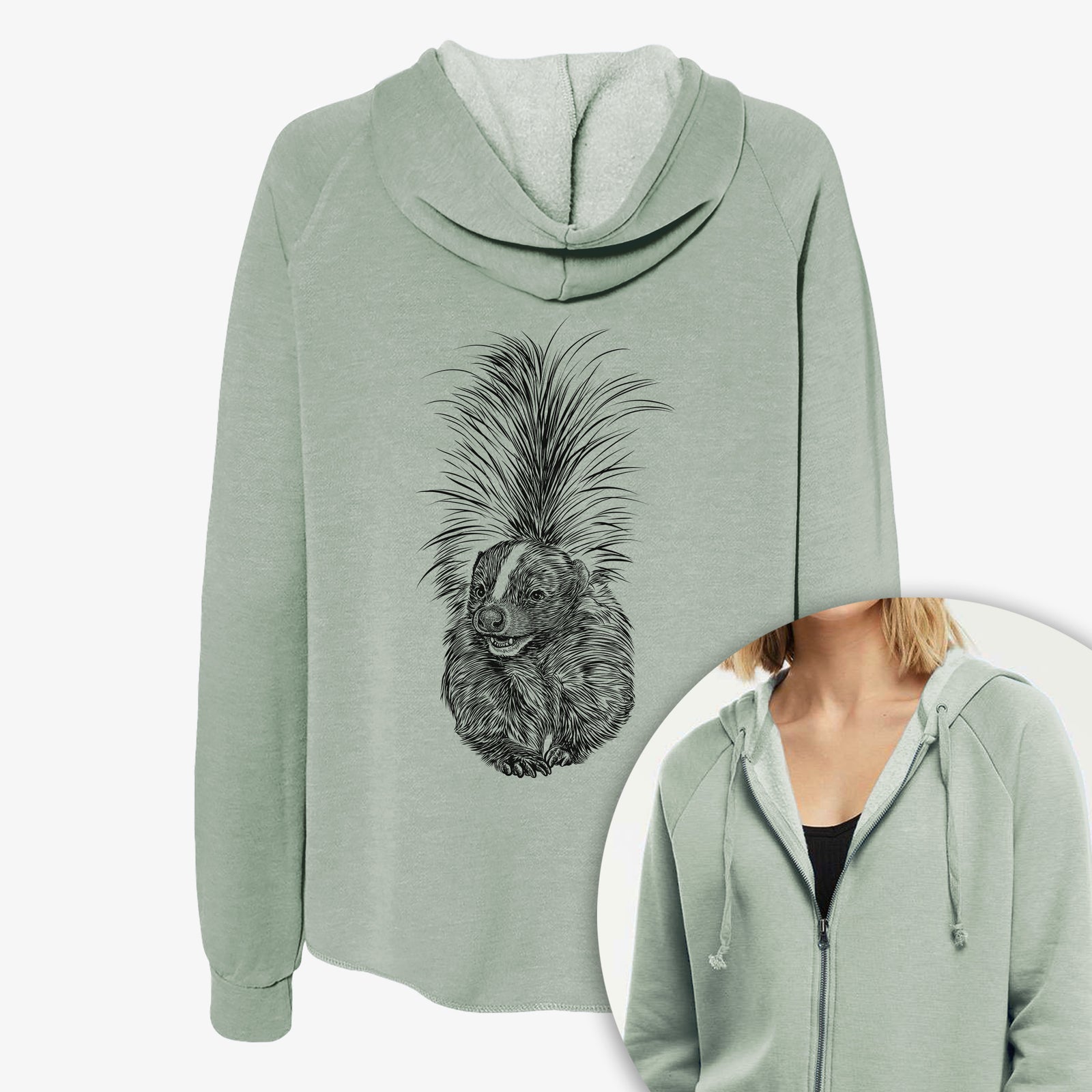 Women's Cali Wave zip-up sweatshirt printed with a detailed black ink illustration of a striped skunk with its tail raised, with a close-up of the zipper.