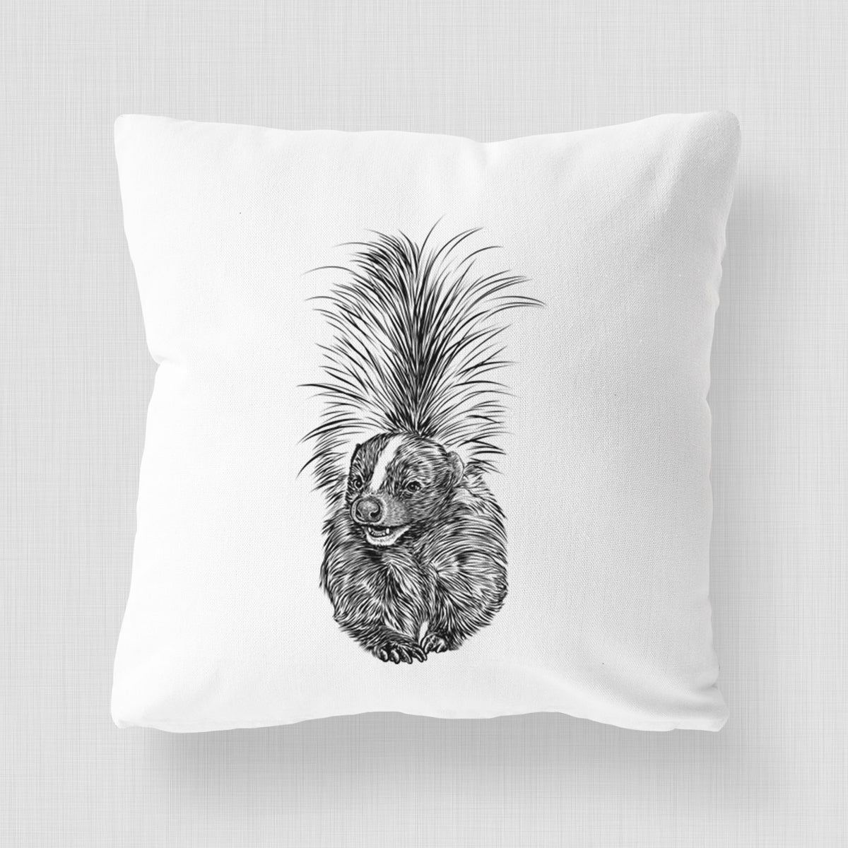 White pillow cover printed with a detailed black ink illustration of a striped skunk with its tail raised.