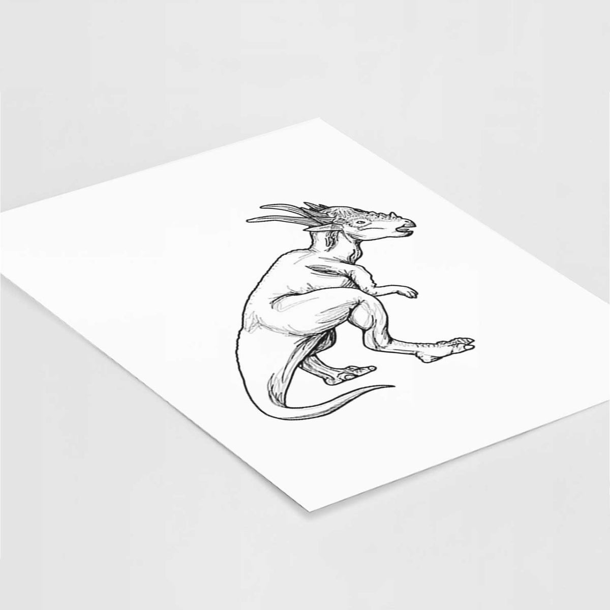 Art print of a black ink illustration of a Stygimoloch dinosaur with a spiky domed head, lying at an angle on a white surface.