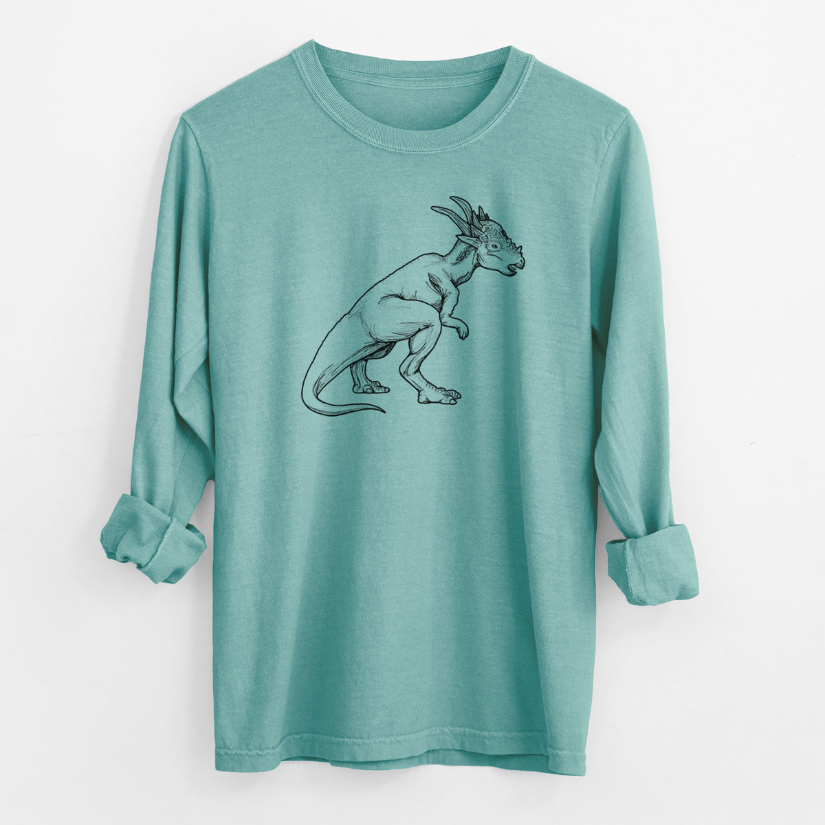Reef green Comfort Colors long sleeve shirt laid flat with the cuffs rolled, printed with a black ink illustration of a Stygimoloch dinosaur with a spiky domed head.