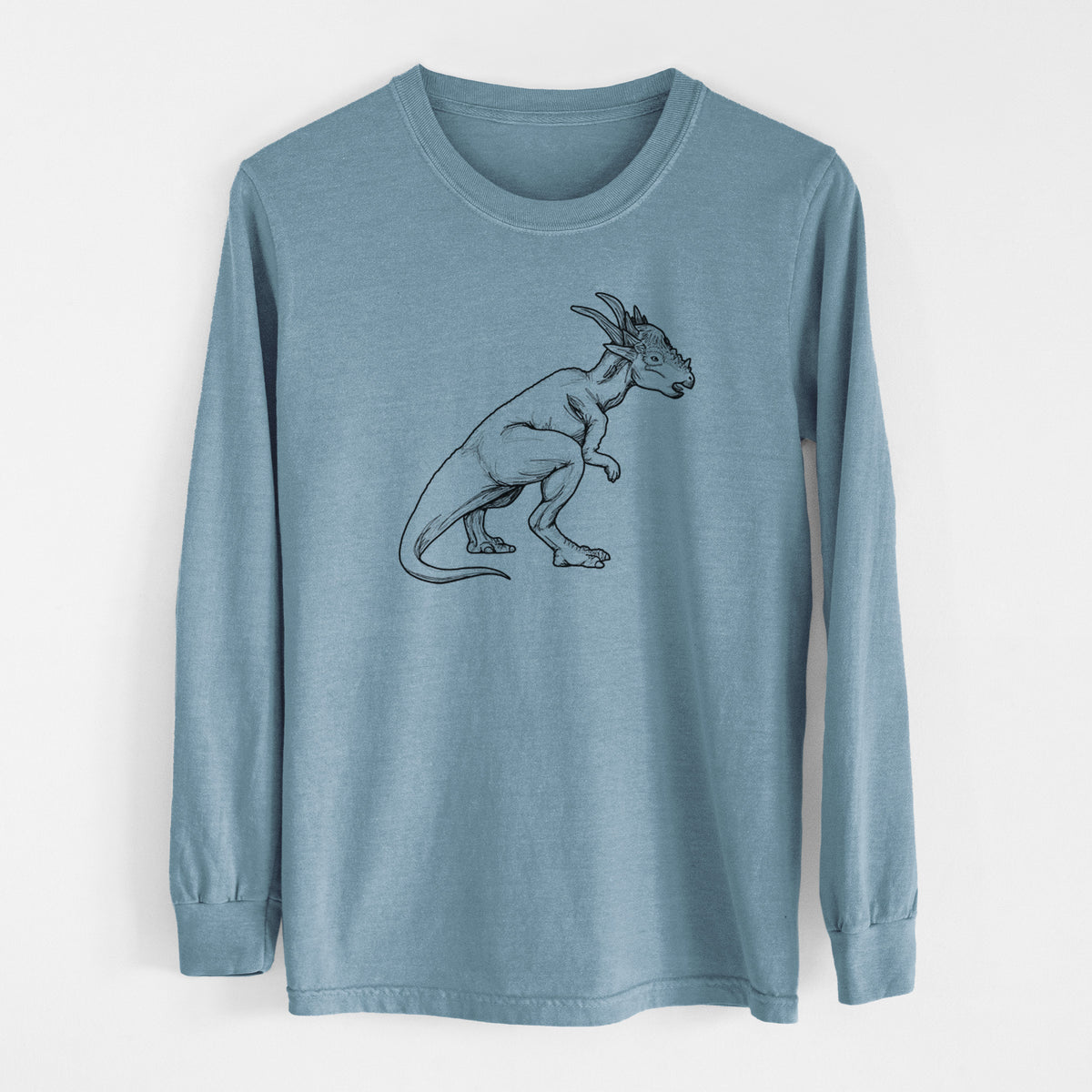 Steel blue Comfort Colors long sleeve shirt laid flat, printed with a black ink illustration of a Stygimoloch dinosaur with a spiky domed head.