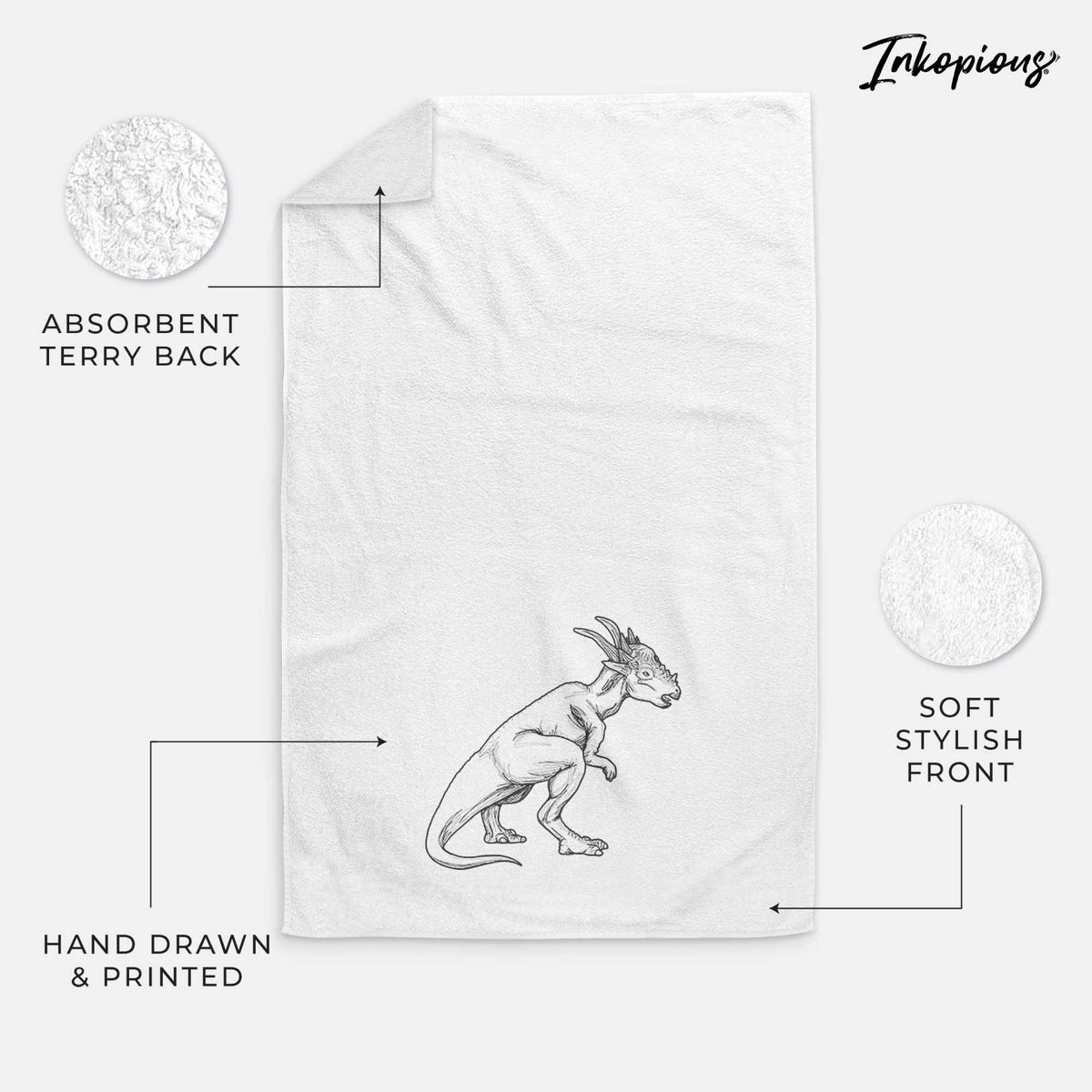 White hand towel printed with a black ink illustration of a Stygimoloch dinosaur with a spiky domed head.