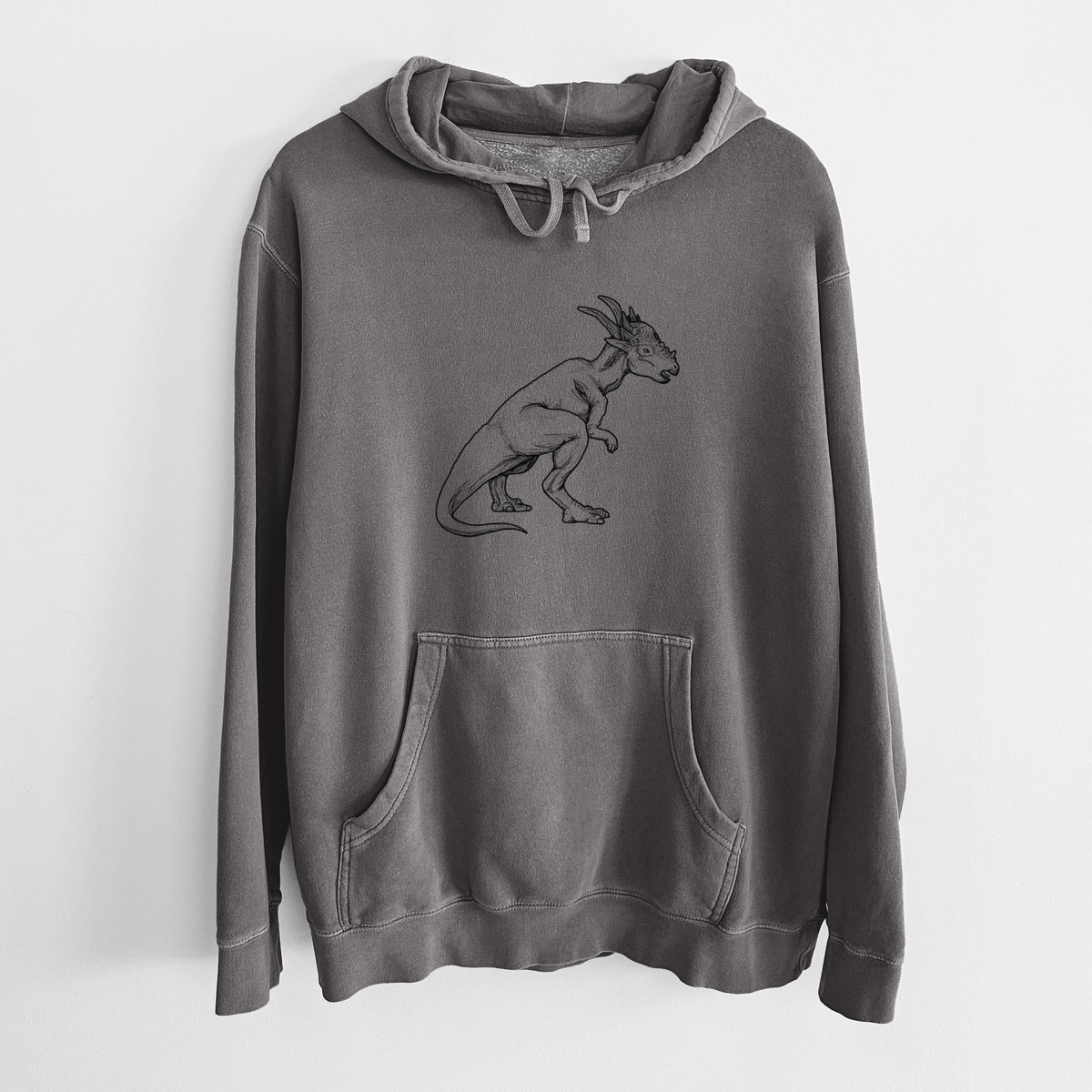 Faded black pigment dyed hoodie laid flat, printed with a black ink illustration of a Stygimoloch dinosaur with a spiky domed head.
