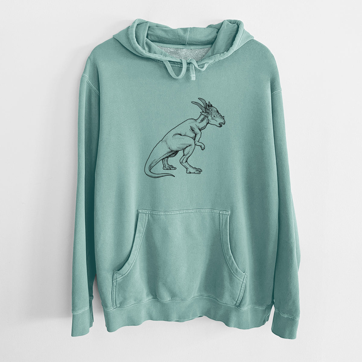 Mint green pigment dyed hoodie laid flat, printed with a black ink illustration of a Stygimoloch dinosaur with a spiky domed head.