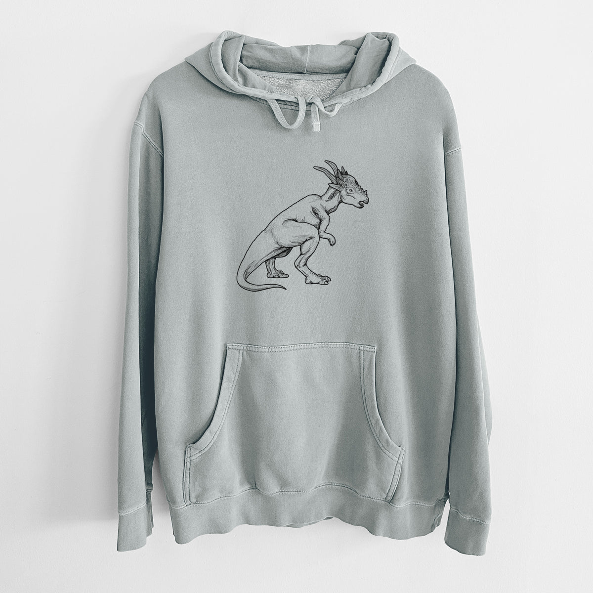 Sage green pigment dyed hoodie laid flat, printed with a black ink illustration of a Stygimoloch dinosaur with a spiky domed head.