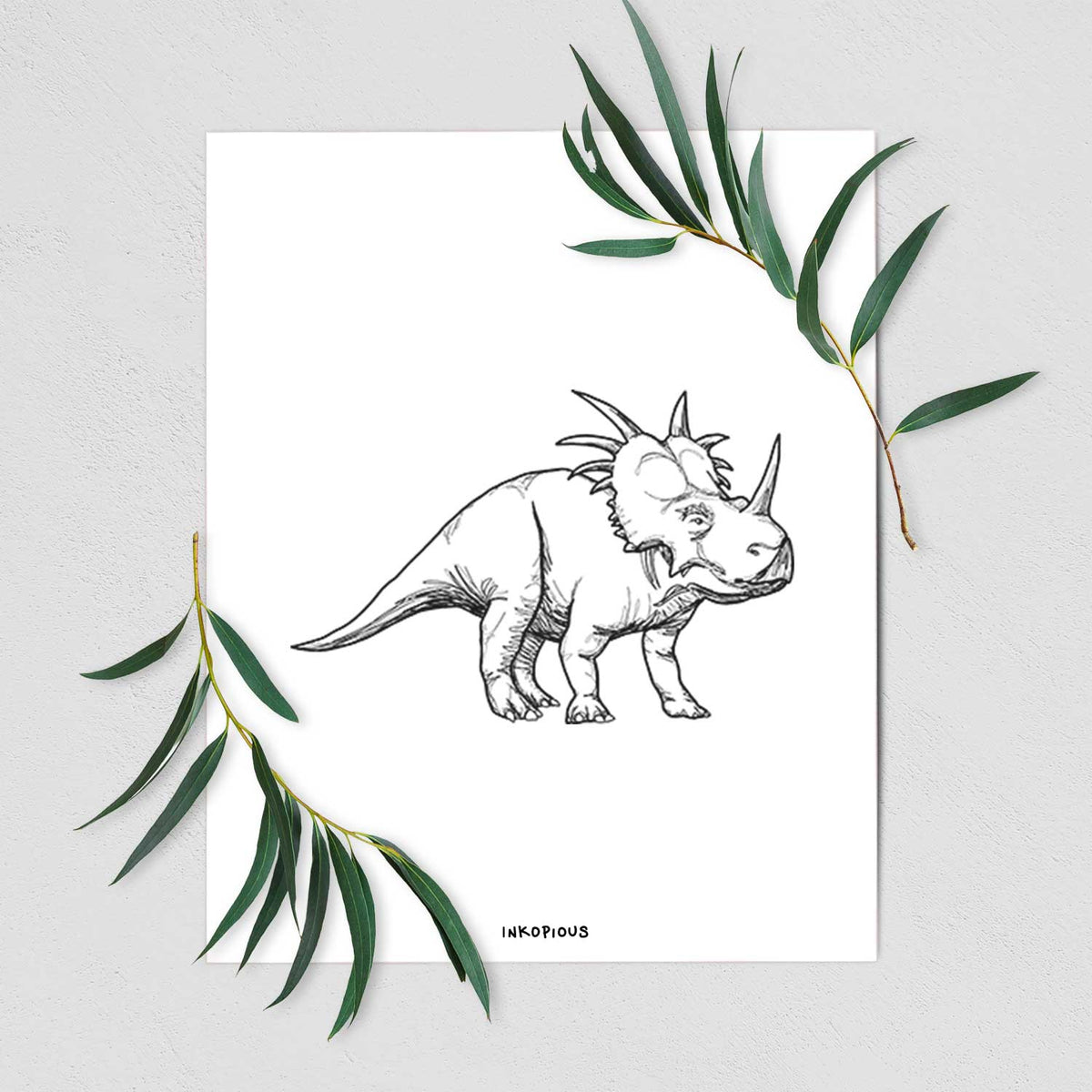 Art print of a black ink illustration of a Styracosaurus with its spiked frill, shown with eucalyptus leaves.