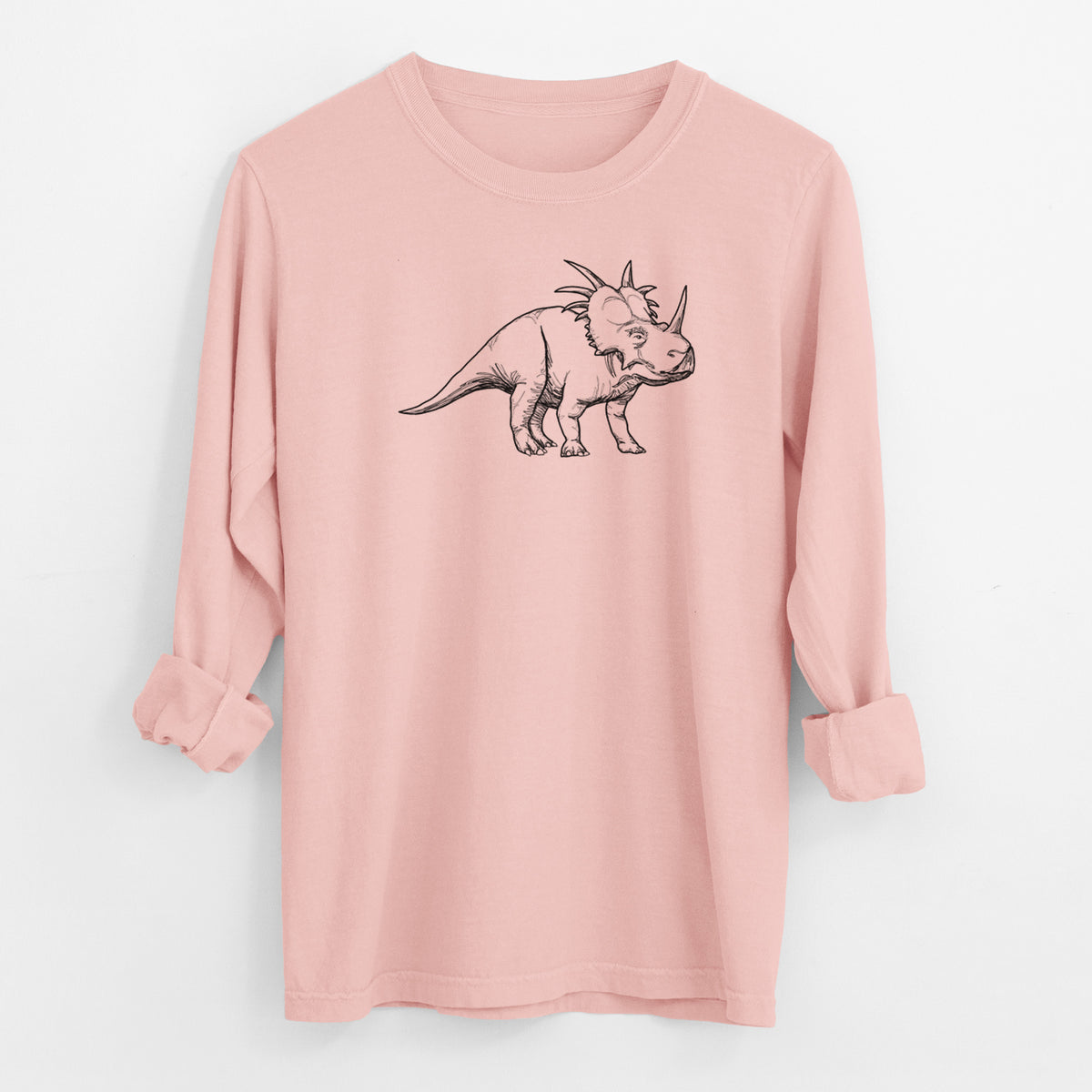Peachy Comfort Colors long sleeve shirt laid flat with the cuffs rolled, printed with a black ink illustration of a Styracosaurus with its spiked frill.