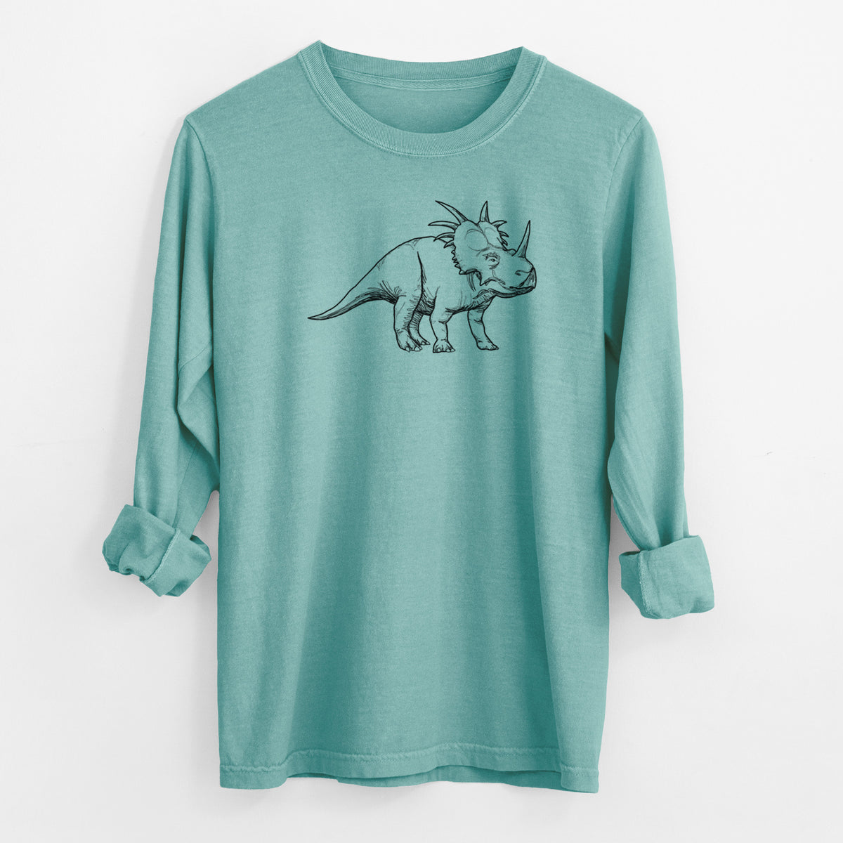 Reef green Comfort Colors long sleeve shirt laid flat with the cuffs rolled, printed with a black ink illustration of a Styracosaurus with its spiked frill.