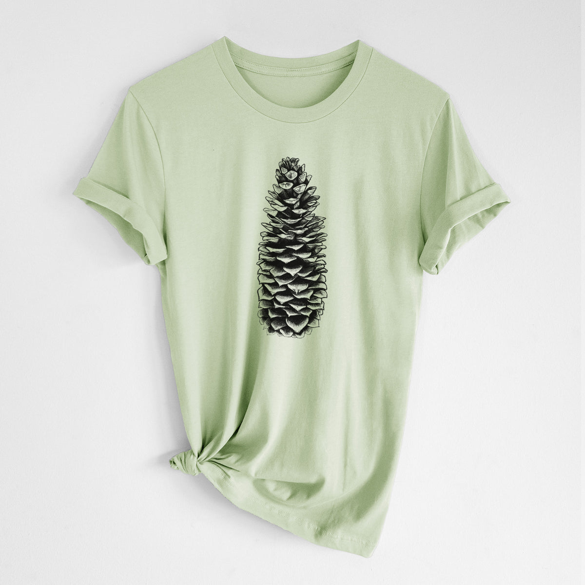 Spring green lightweight cotton t-shirt laid flat with the sleeves rolled, printed with a detailed black ink illustration of a long sugar pine cone.