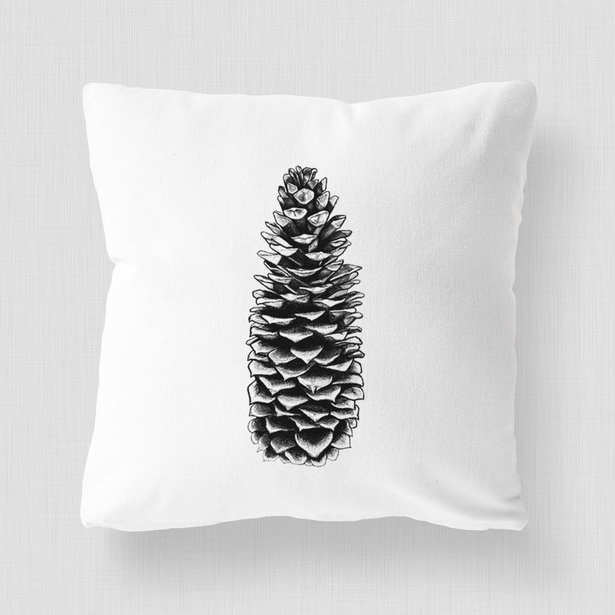 White pillow cover printed with a detailed black ink illustration of a long sugar pine cone.