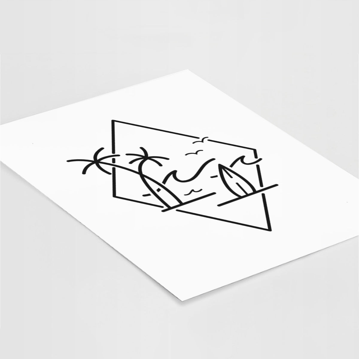 Art print of black line art of palm trees, ocean waves, birds and a surfboard inside a diamond outline, lying at an angle on a white surface.