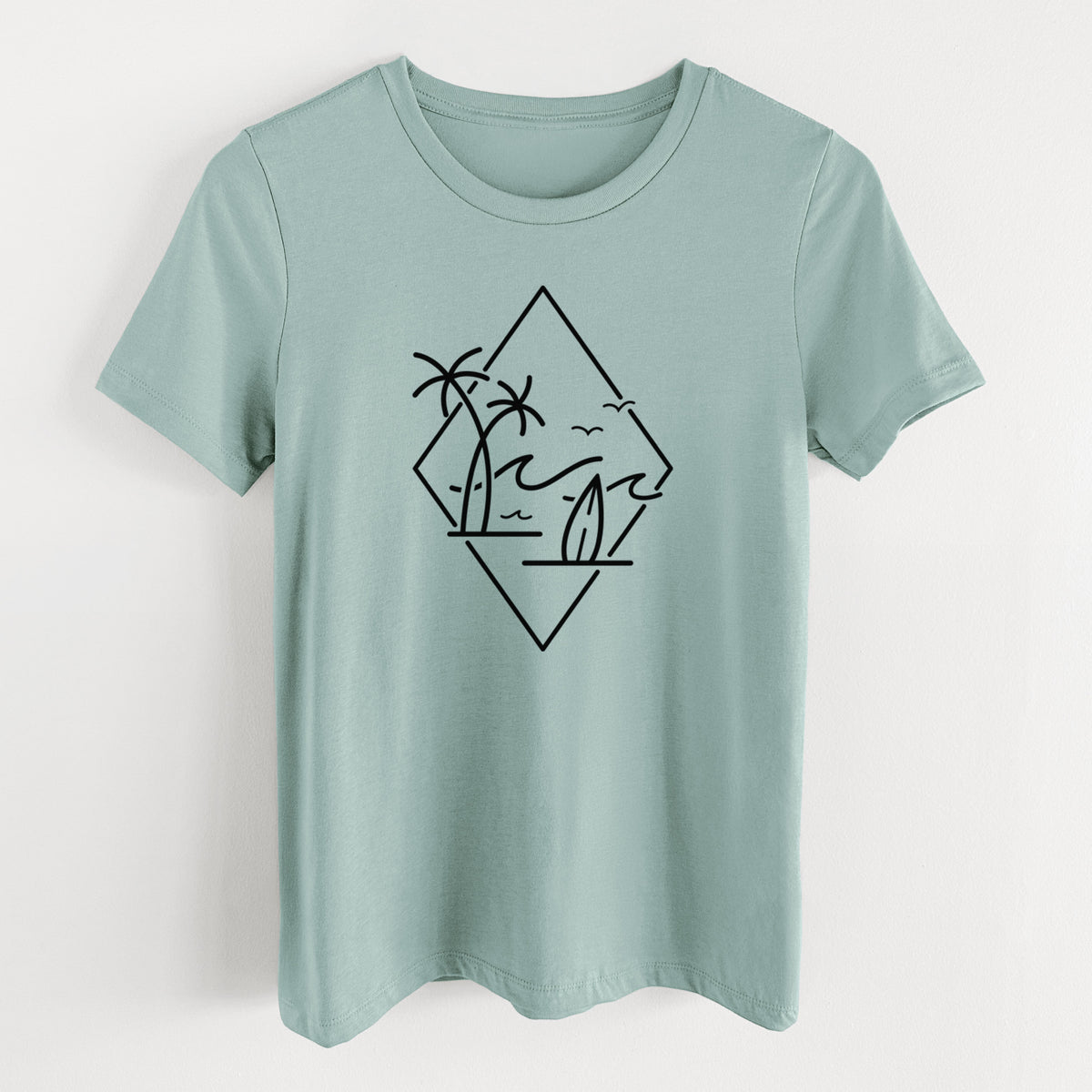 Dusty blue women's relaxed fit cotton t-shirt laid flat, printed with black line art of palm trees, ocean waves, birds and a surfboard inside a diamond outline.