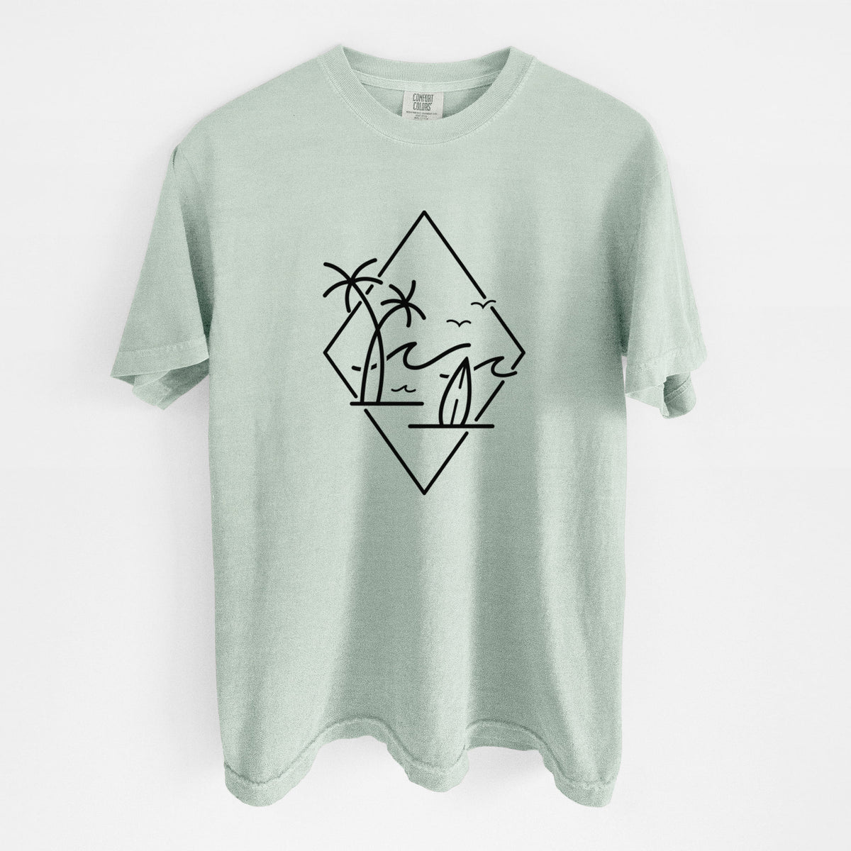 Bay green Comfort Colors t-shirt laid flat, printed with black line art of palm trees, ocean waves, birds and a surfboard inside a diamond outline.