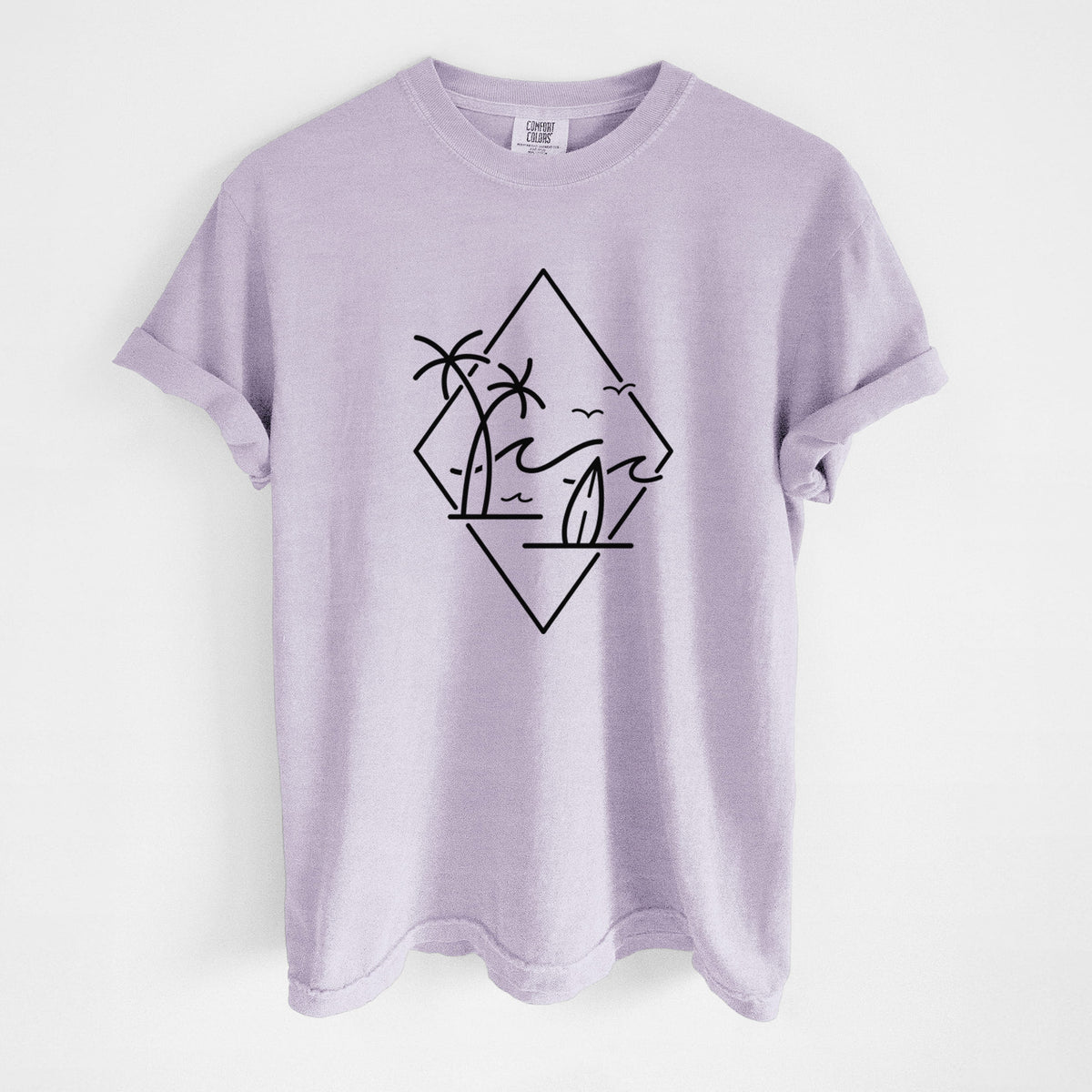 Orchid purple Comfort Colors t-shirt laid flat, printed with black line art of palm trees, ocean waves, birds and a surfboard inside a diamond outline.