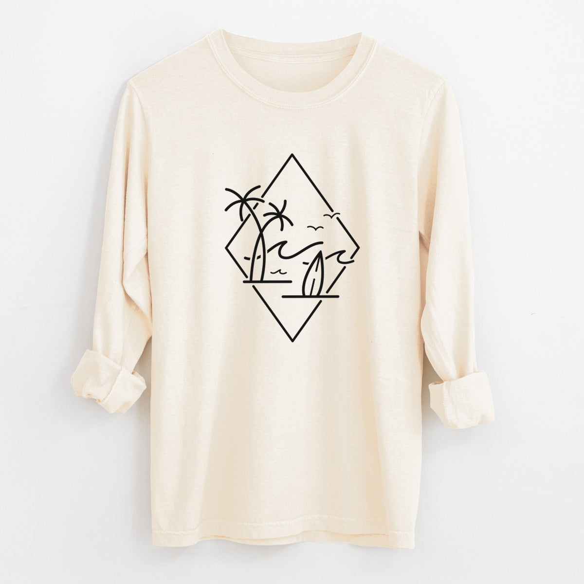 Ivory Comfort Colors long sleeve shirt laid flat with the cuffs rolled, printed with black line art of palm trees, ocean waves, birds and a surfboard inside a diamond outline.