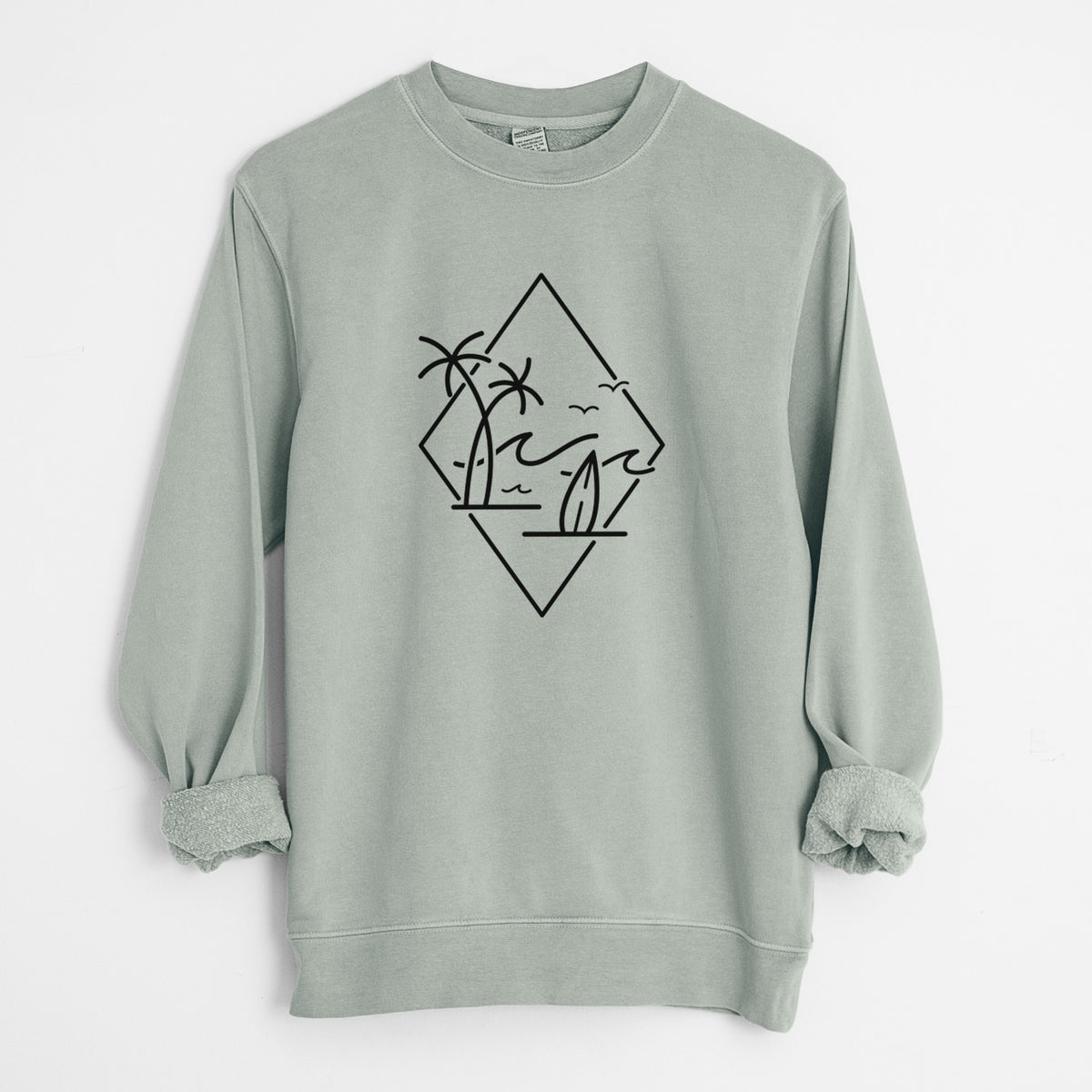Sage green pigment dyed crewneck sweatshirt laid flat with the sleeves rolled, printed with black line art of palm trees, ocean waves, birds and a surfboard inside a diamond outline.