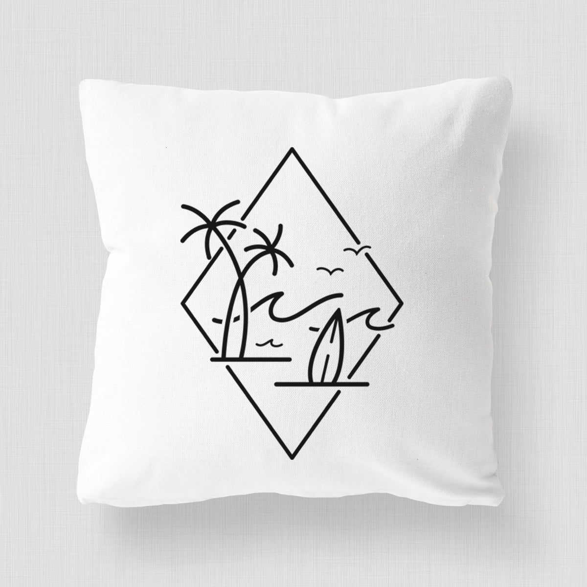 White pillow cover printed with black line art of palm trees, ocean waves, birds and a surfboard inside a diamond outline.