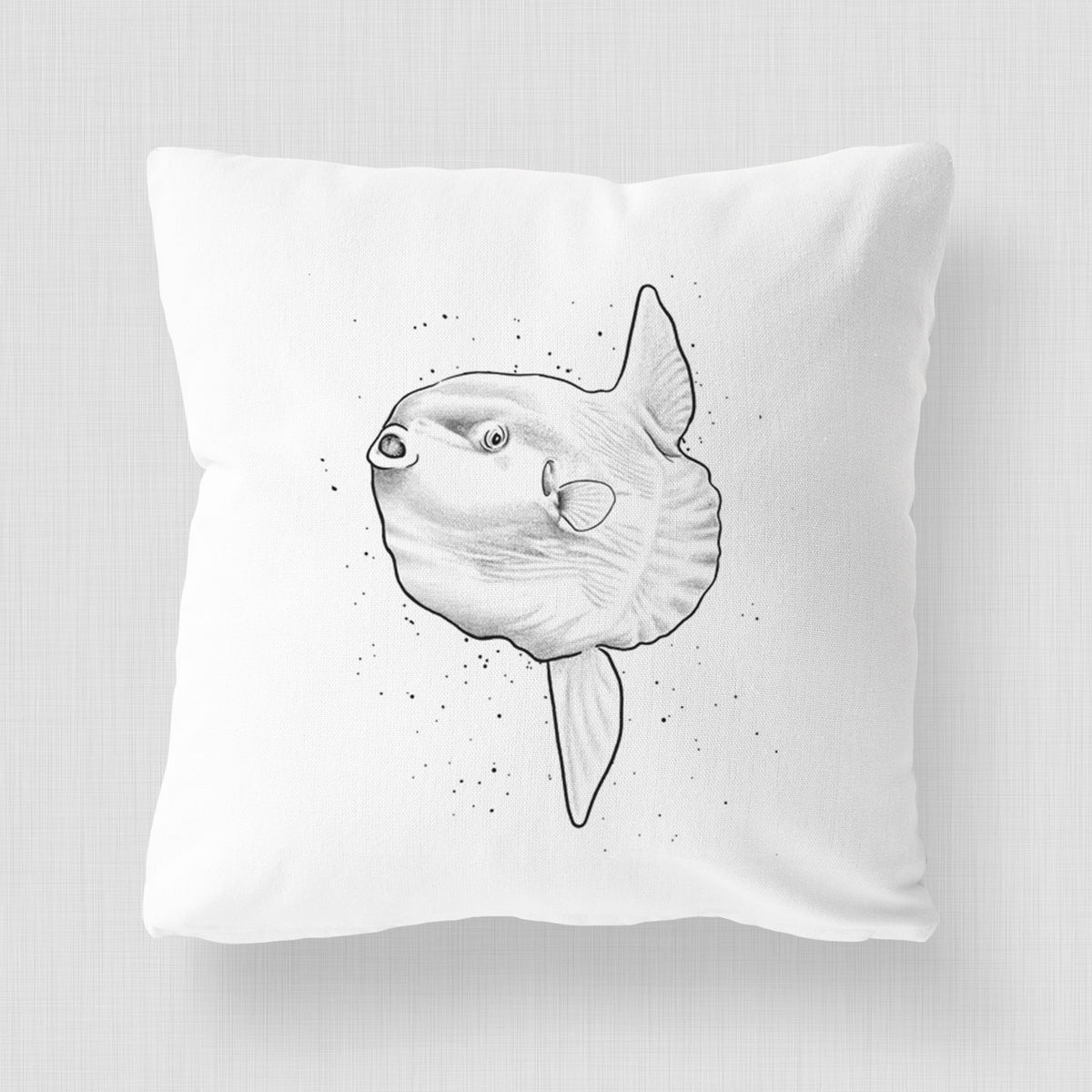 White pillow cover printed with a black ink illustration of an ocean sunfish swimming.
