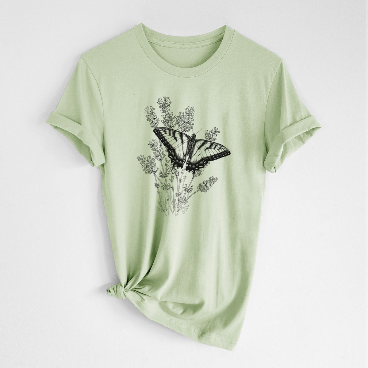 Spring green lightweight cotton t-shirt laid flat with the sleeves rolled, printed with a black ink illustration of a swallowtail butterfly resting on lavender.