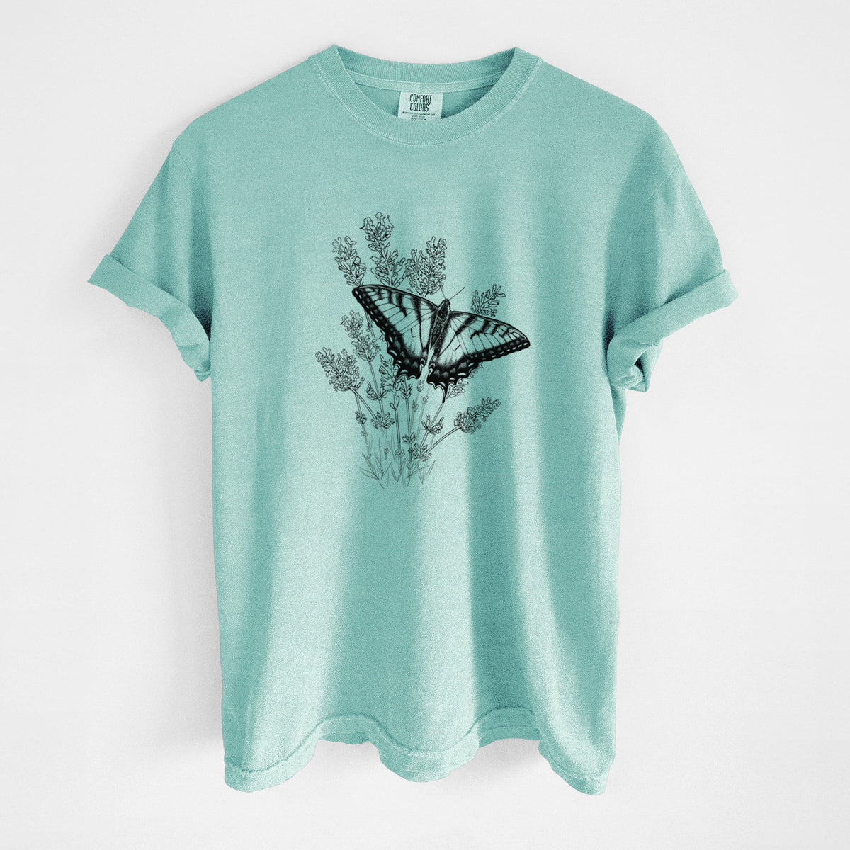 Chalky mint Comfort Colors t-shirt laid flat, printed with a black ink illustration of a swallowtail butterfly resting on lavender.