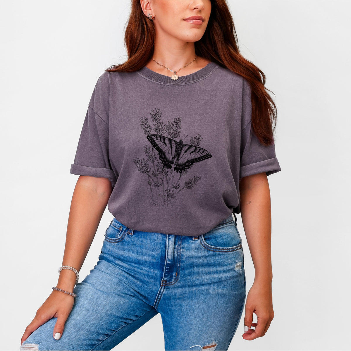 Woman wearing a Comfort Colors t-shirt printed with a black ink illustration of a swallowtail butterfly resting on lavender.