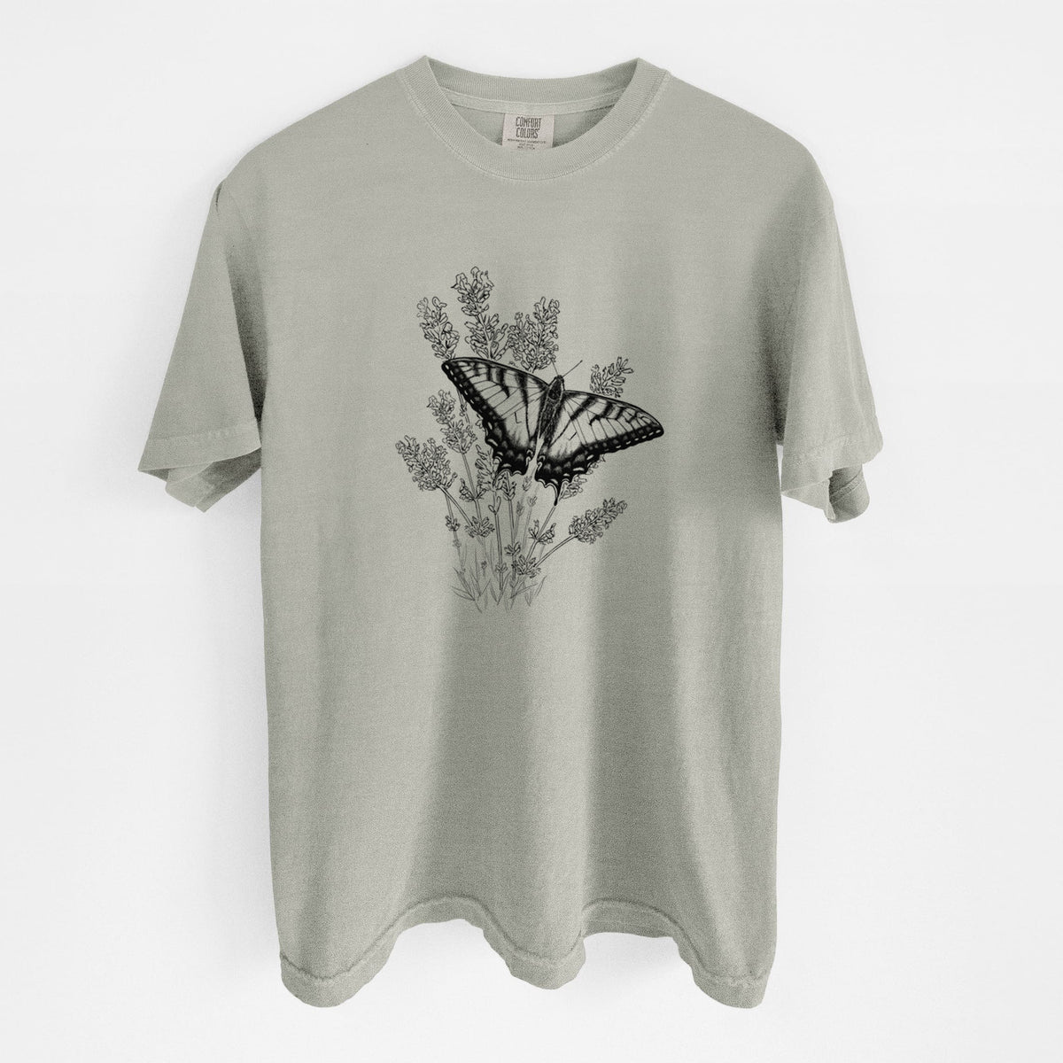 Sandstone beige Comfort Colors t-shirt laid flat, printed with a black ink illustration of a swallowtail butterfly resting on lavender.