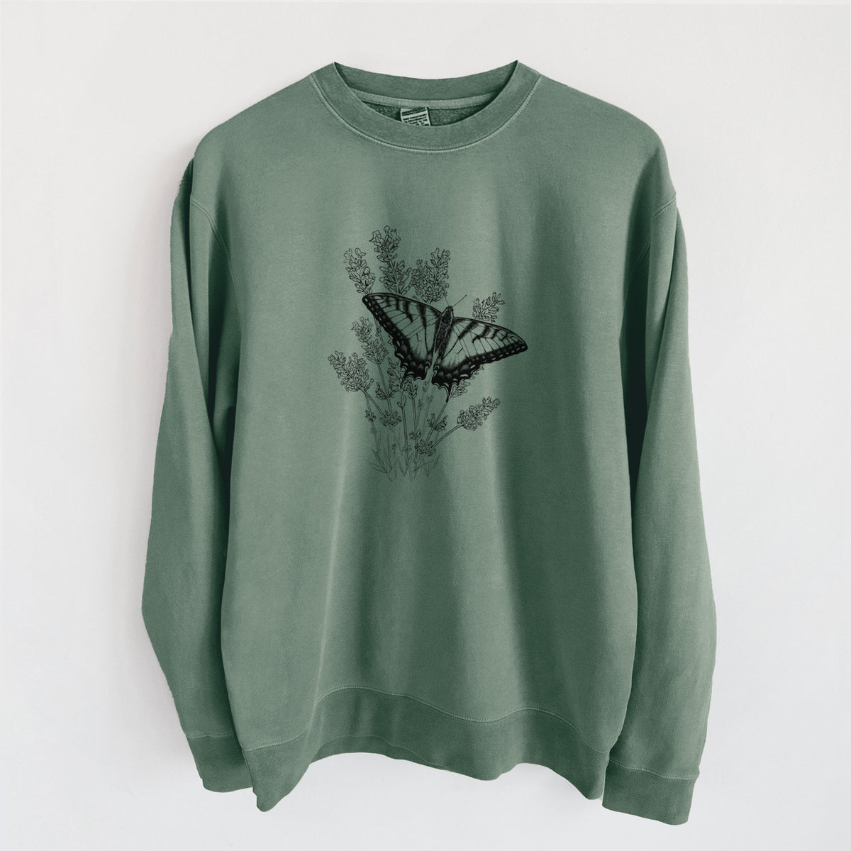 Alpine green pigment dyed crewneck sweatshirt laid flat, printed with a black ink illustration of a swallowtail butterfly resting on lavender.