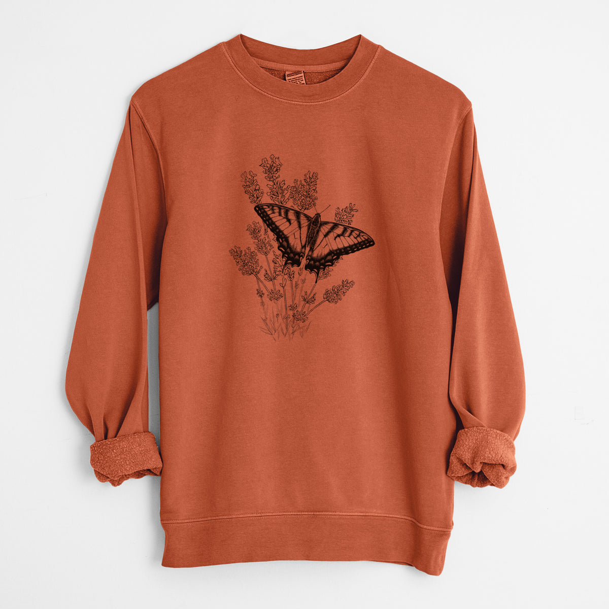 Amber orange pigment dyed crewneck sweatshirt laid flat with the sleeves rolled, printed with a black ink illustration of a swallowtail butterfly resting on lavender.