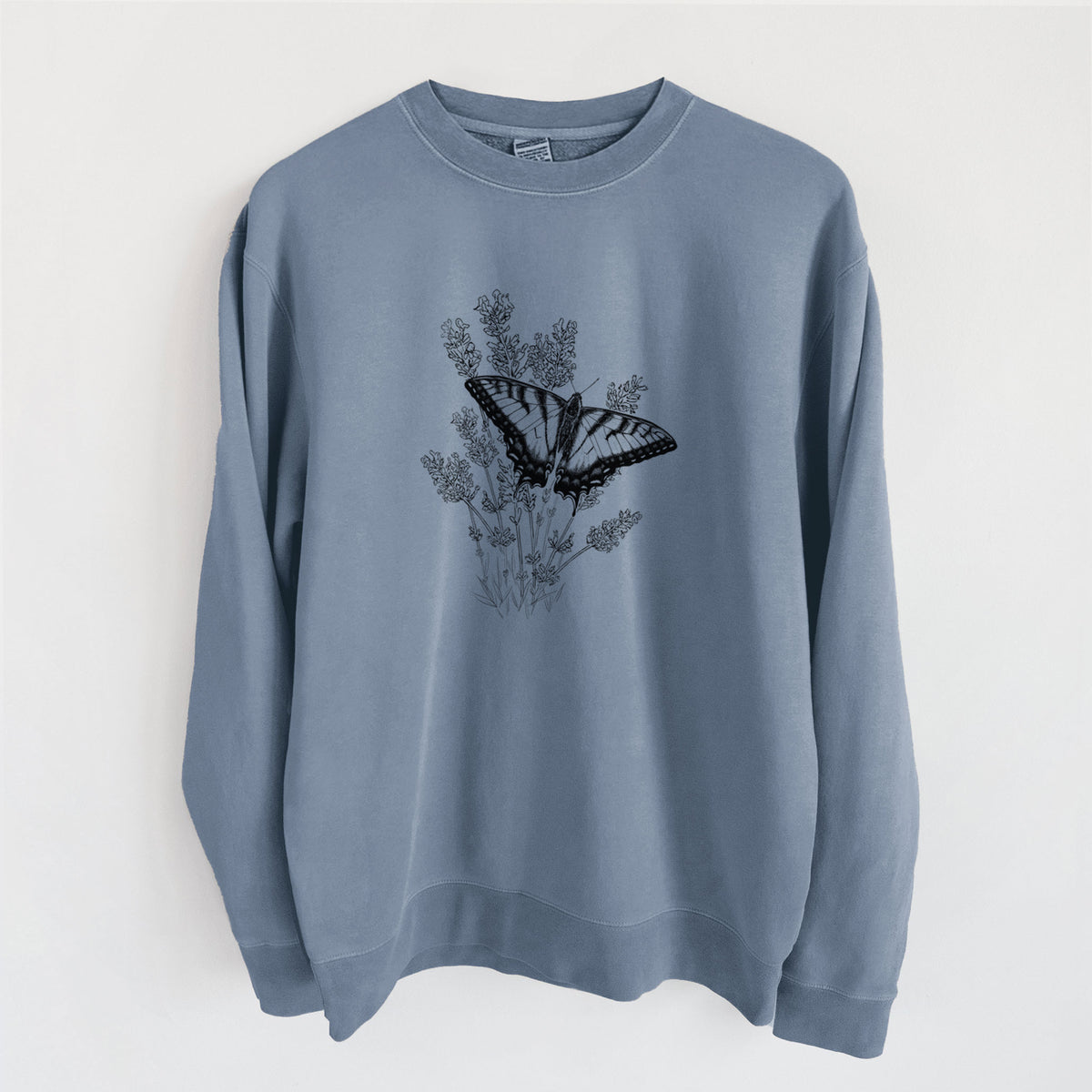 Slate blue pigment dyed crewneck sweatshirt laid flat, printed with a black ink illustration of a swallowtail butterfly resting on lavender.