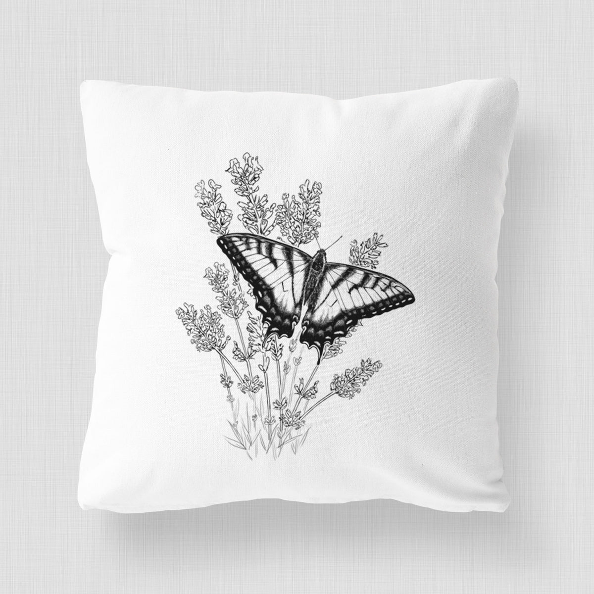 White pillow cover printed with a black ink illustration of a swallowtail butterfly resting on lavender.
