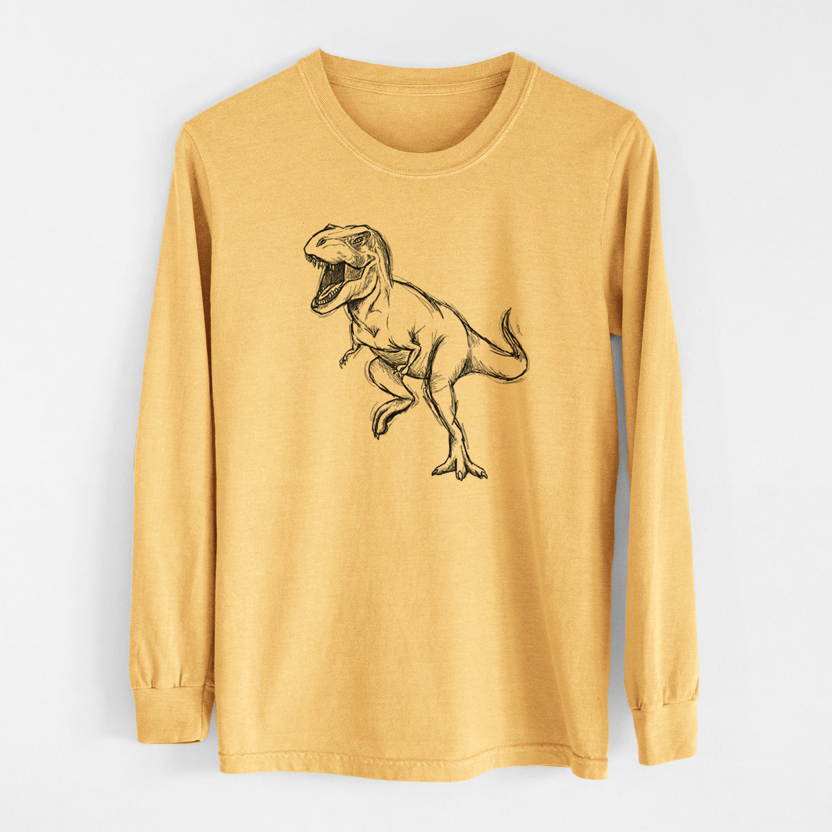 Golden wheat yellow Comfort Colors long sleeve shirt laid flat, printed with a black ink illustration of a Tyrannosaurus rex roaring.