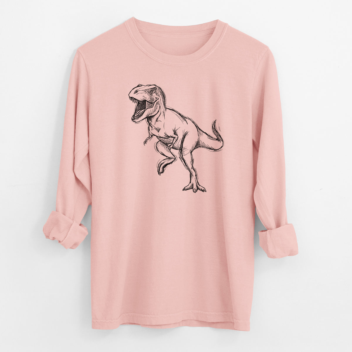Peachy Comfort Colors long sleeve shirt laid flat with the cuffs rolled, printed with a black ink illustration of a Tyrannosaurus rex roaring.
