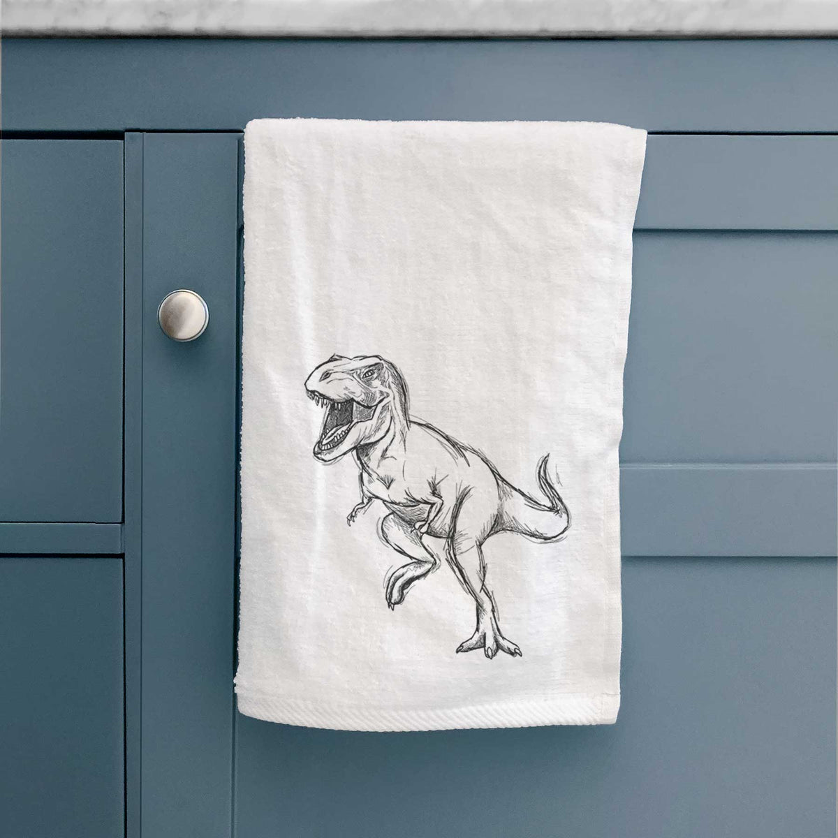 White hand towel printed with a black ink illustration of a Tyrannosaurus rex roaring.