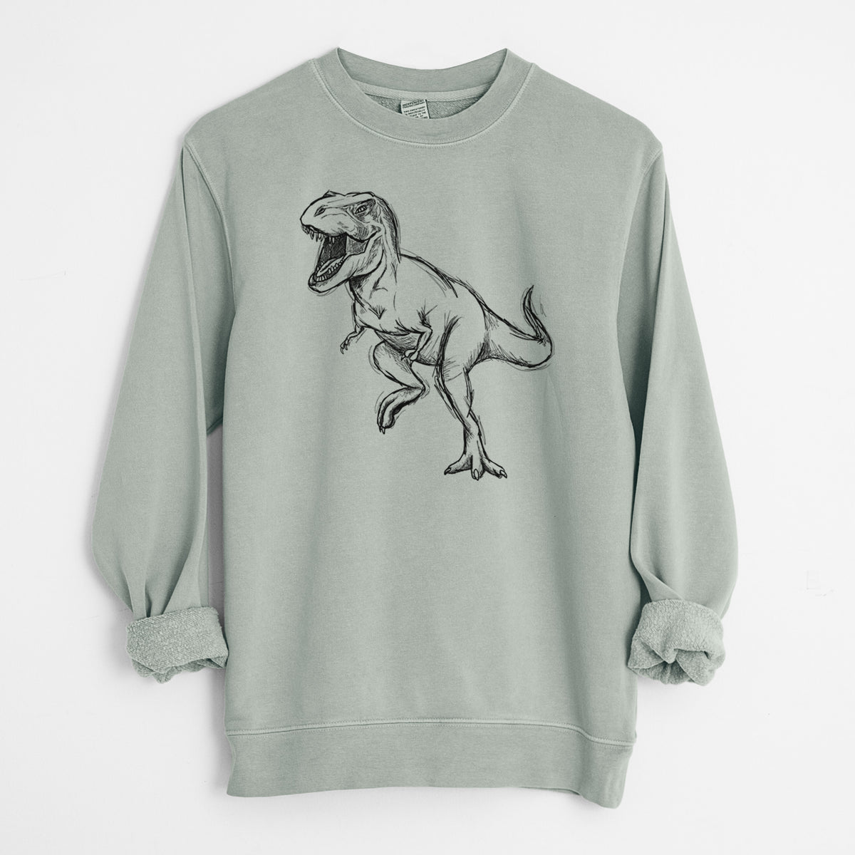 Sage green pigment dyed crewneck sweatshirt laid flat with the sleeves rolled, printed with a black ink illustration of a Tyrannosaurus rex roaring.