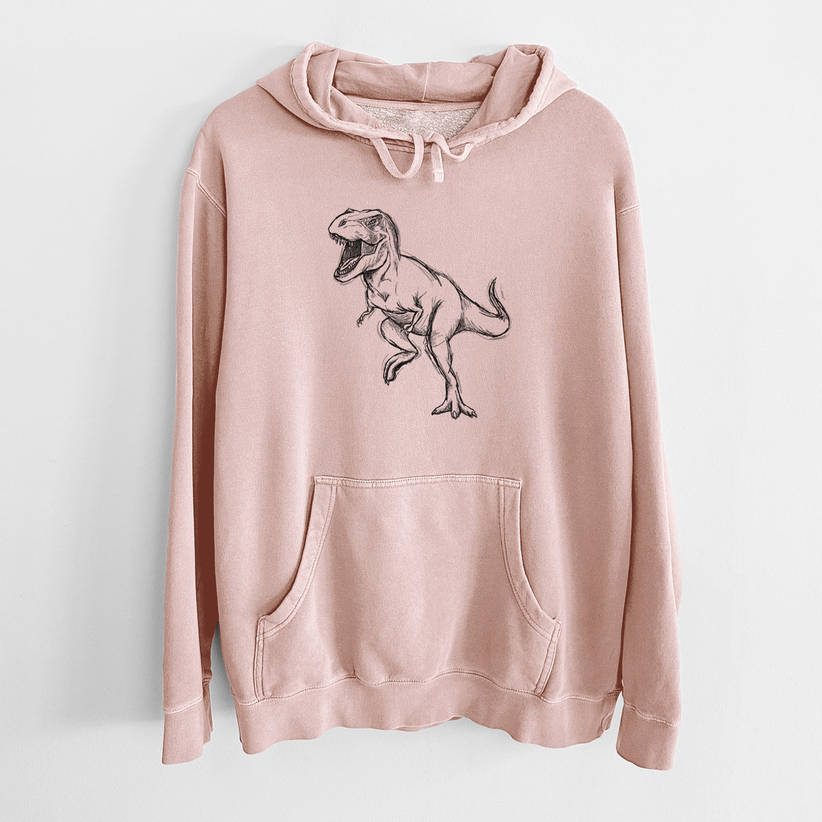 Dusty pink pigment dyed hoodie laid flat, printed with a black ink illustration of a Tyrannosaurus rex roaring.