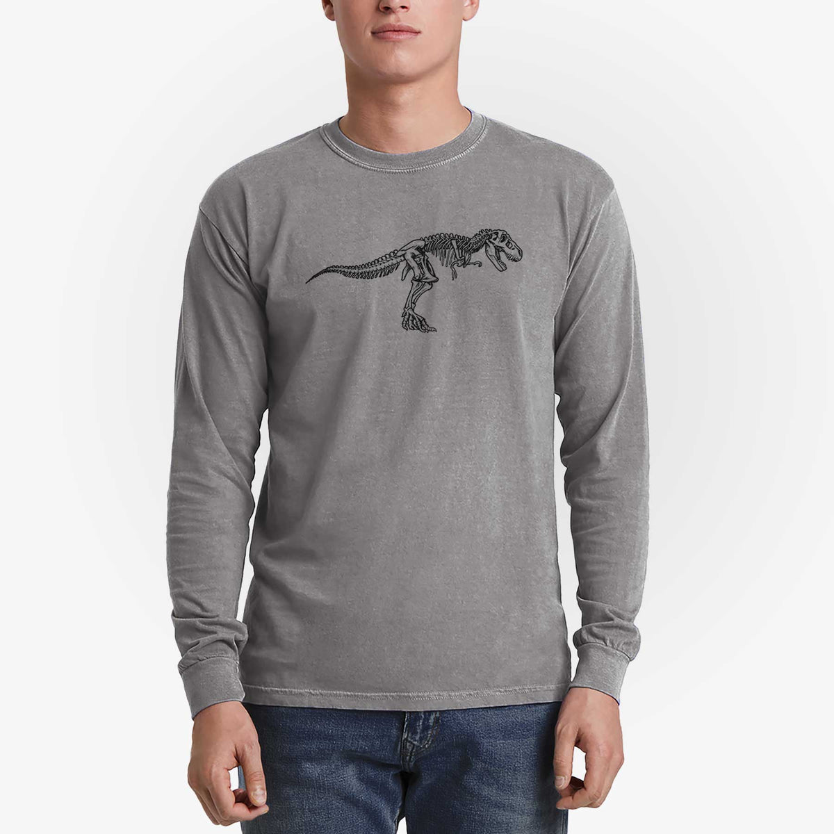 Man wearing a grey Comfort Colors long sleeve shirt printed with a black ink illustration of a Tyrannosaurus rex skeleton.