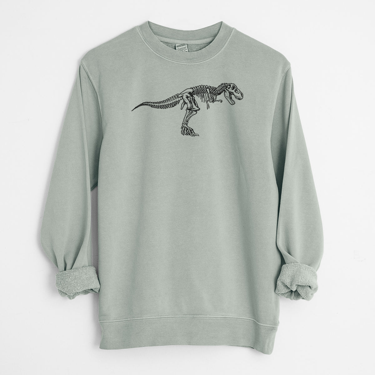 Sage green pigment dyed crewneck sweatshirt laid flat with the sleeves rolled, printed with a black ink illustration of a Tyrannosaurus rex skeleton.