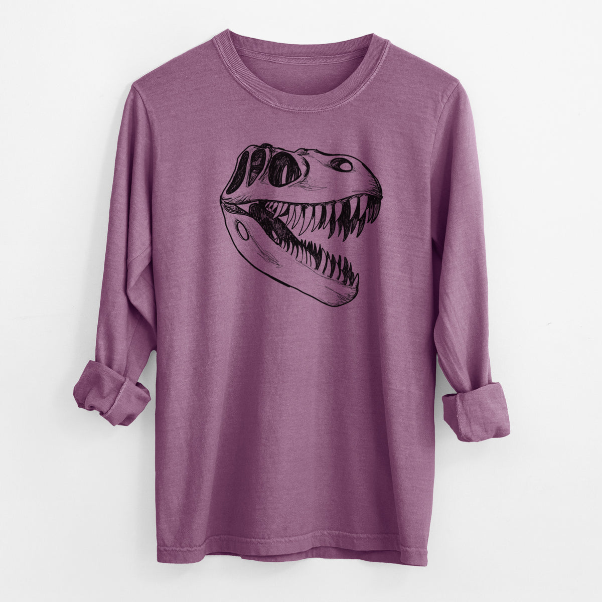 Berry pink Comfort Colors long sleeve shirt laid flat with the cuffs rolled, printed with a black ink illustration of a Tyrannosaurus rex skull with sharp teeth.