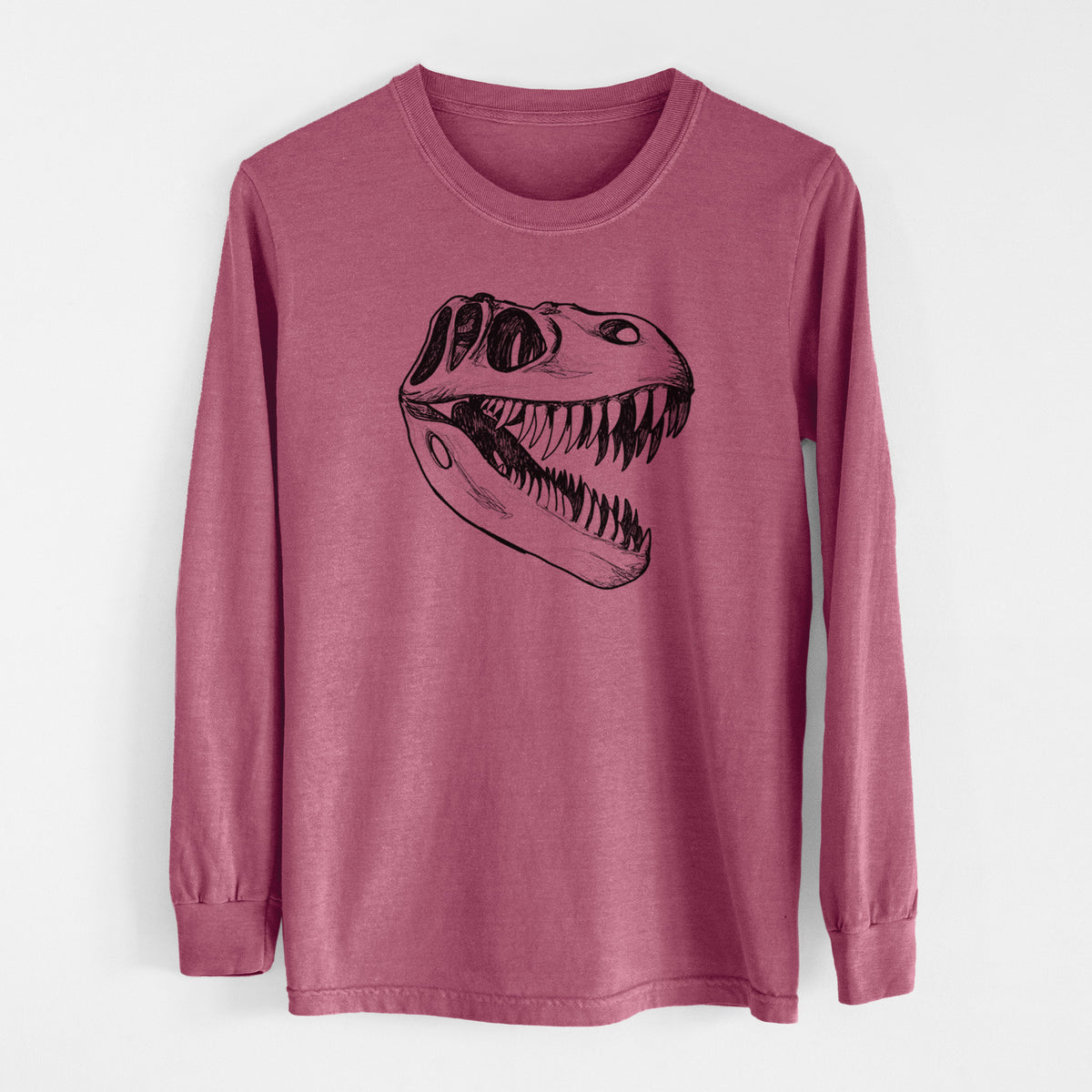 Crimson Comfort Colors long sleeve shirt laid flat, printed with a black ink illustration of a Tyrannosaurus rex skull with sharp teeth.