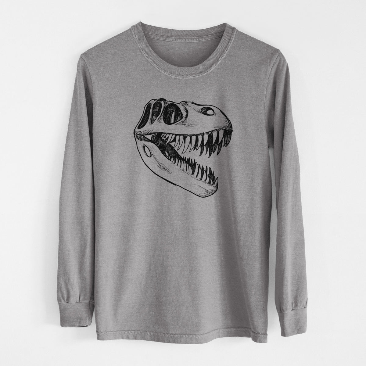 Grey Comfort Colors long sleeve shirt laid flat, printed with a black ink illustration of a Tyrannosaurus rex skull with sharp teeth.
