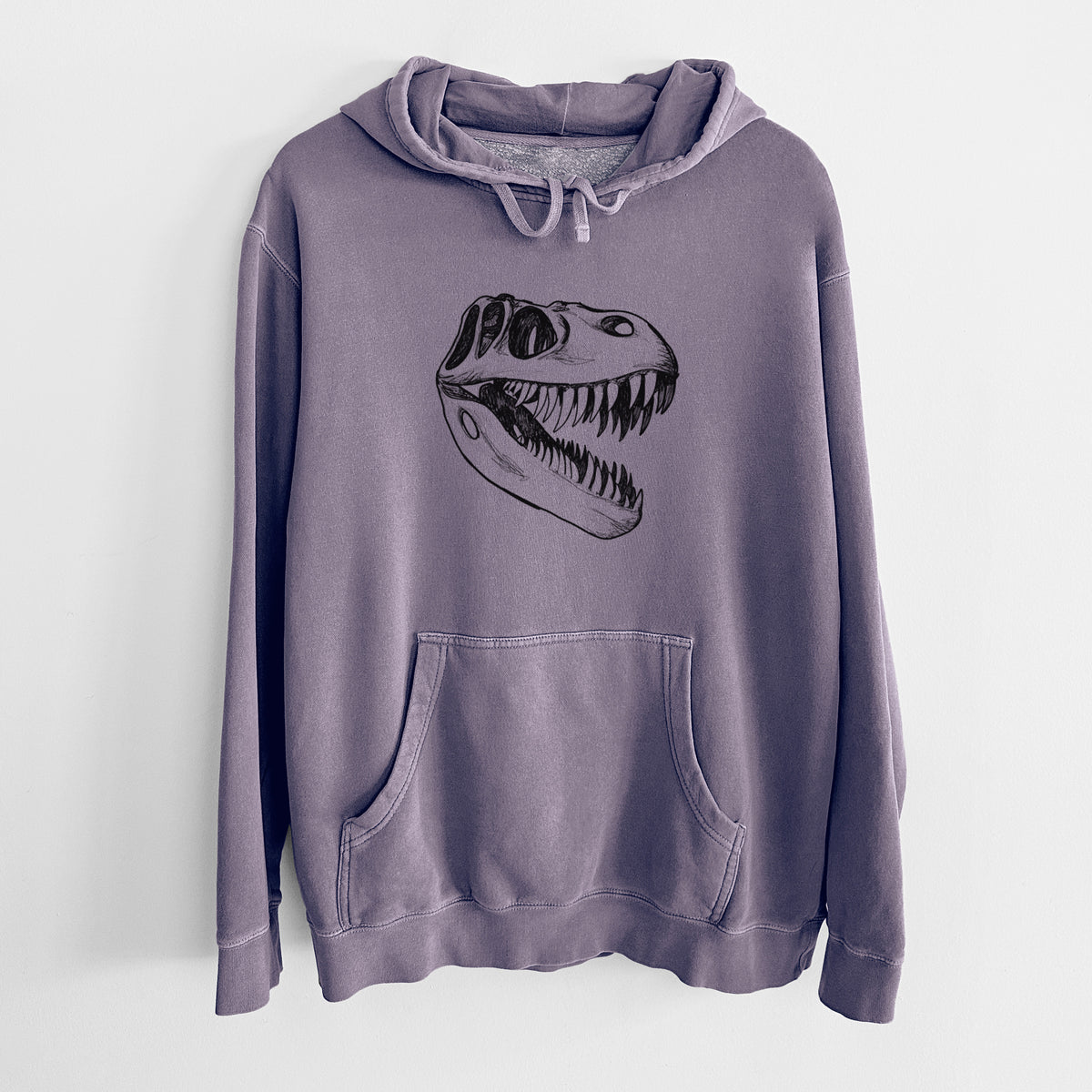 Plum purple pigment dyed hoodie laid flat, printed with a black ink illustration of a Tyrannosaurus rex skull with sharp teeth.