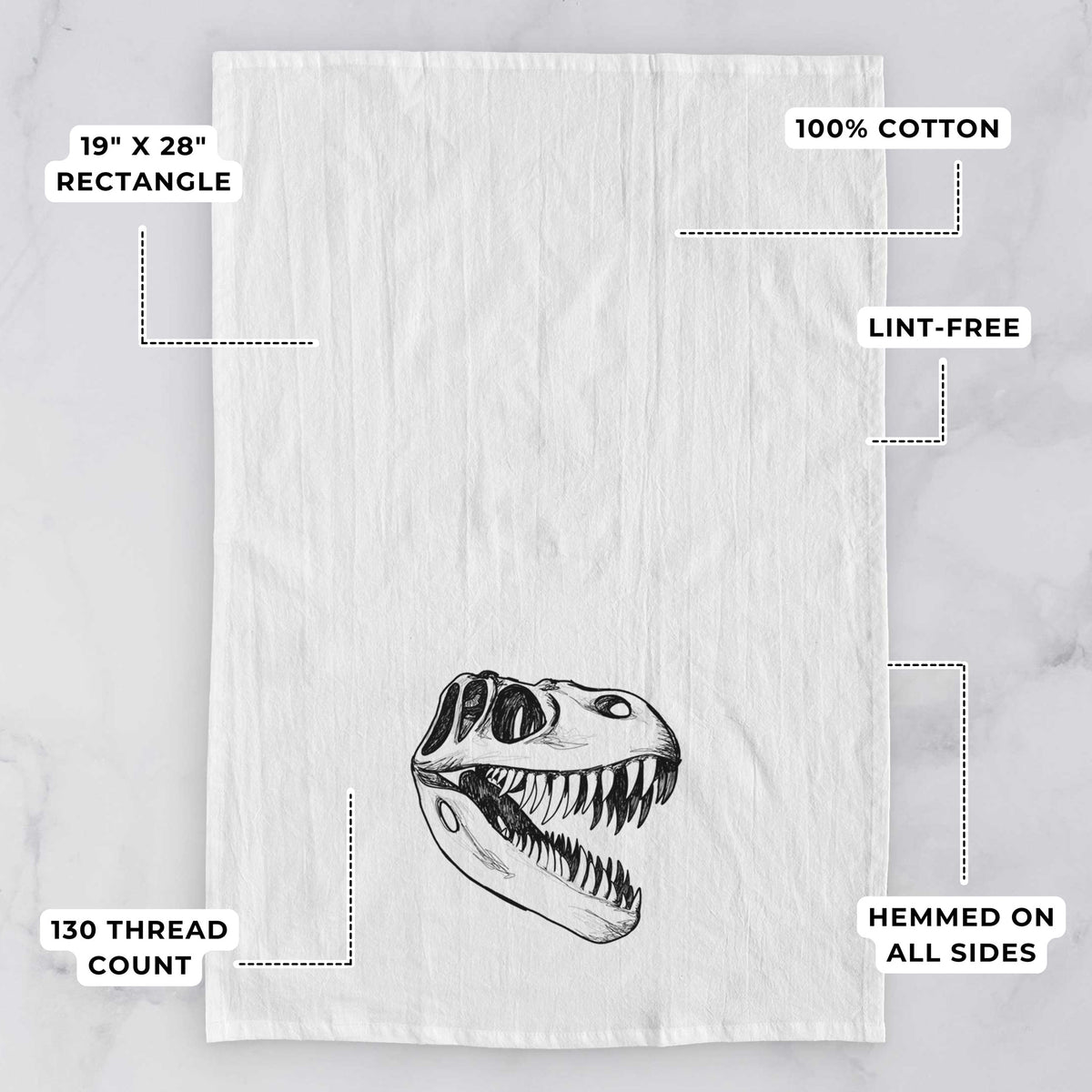 White tea towel printed with a black ink illustration of a Tyrannosaurus rex skull with sharp teeth, with feature labels: 19 by 28 inch rectangle, 100% cotton, lint-free, 130 thread count, hemmed on all sides.