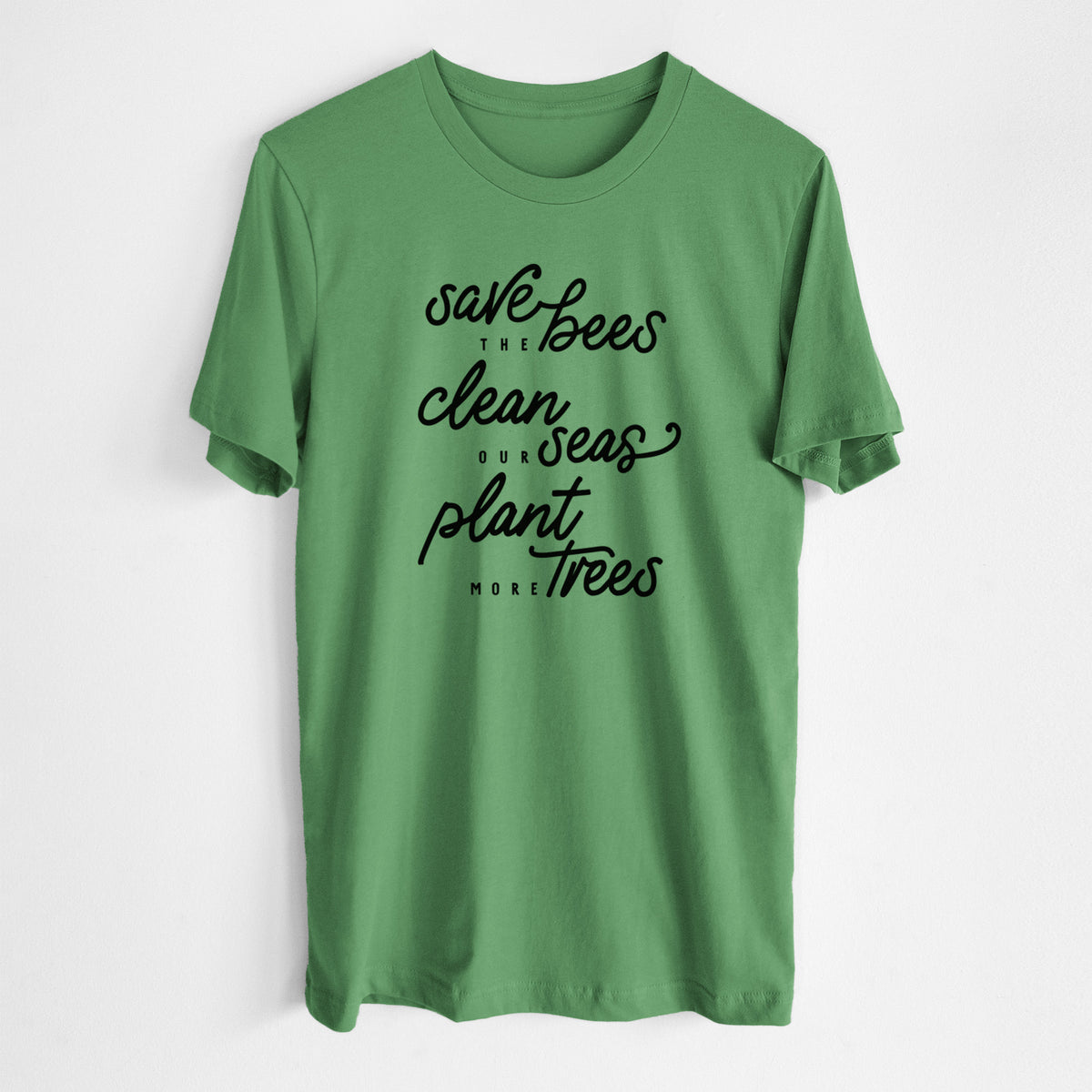 Leaf green lightweight cotton t-shirt laid flat, printed with black hand-lettered words reading Save the Bees, Clean Our Seas, Plant More Trees.