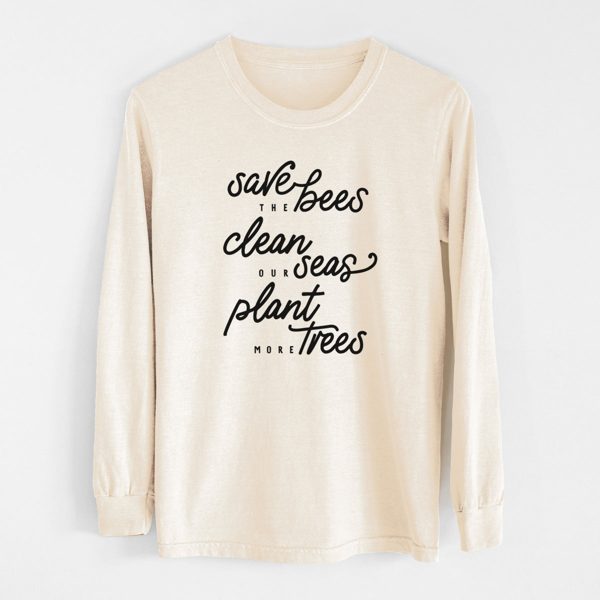 Ivory Comfort Colors long sleeve shirt laid flat, printed with black hand-lettered words reading Save the Bees, Clean Our Seas, Plant More Trees.