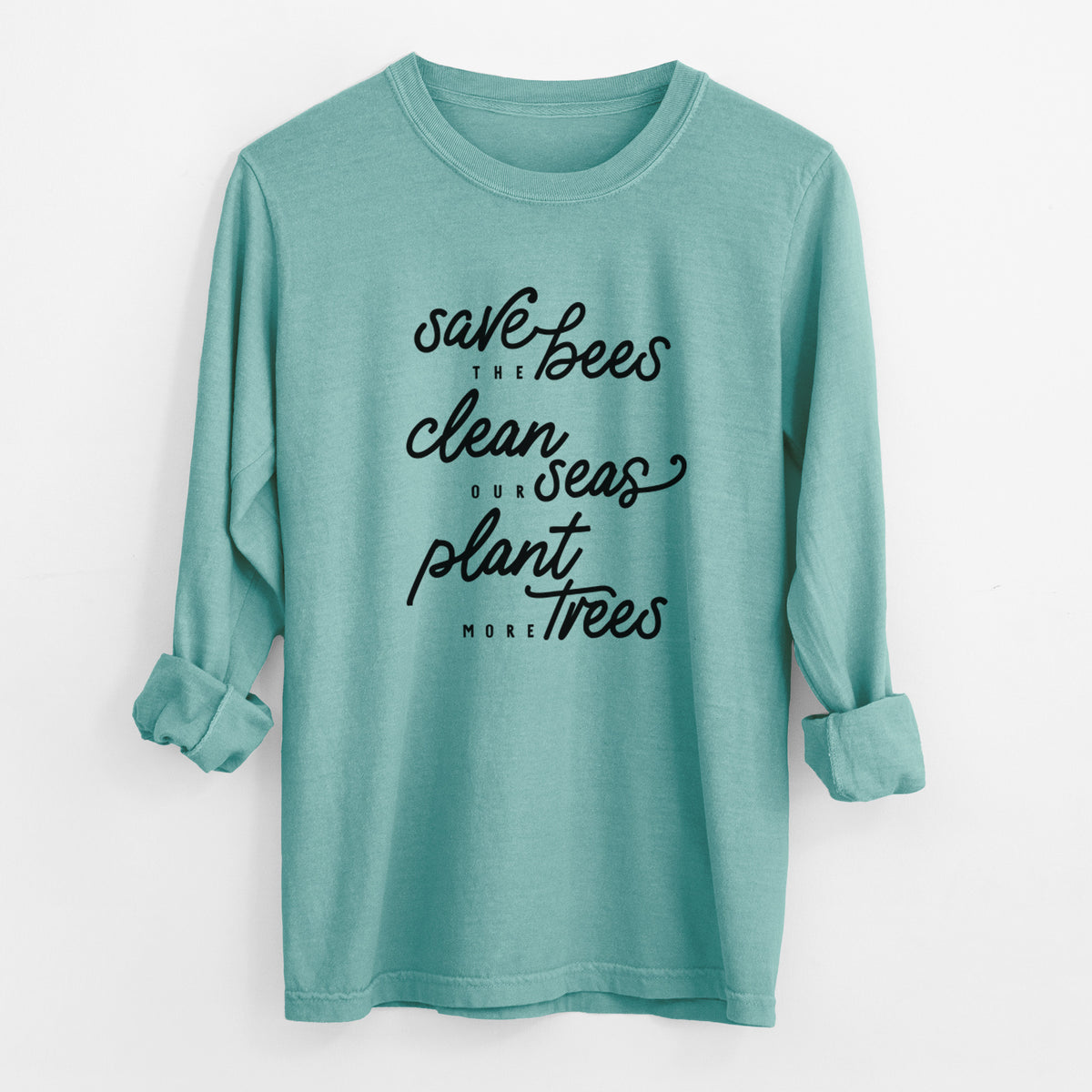 Reef green Comfort Colors long sleeve shirt laid flat with the cuffs rolled, printed with black hand-lettered words reading Save the Bees, Clean Our Seas, Plant More Trees.