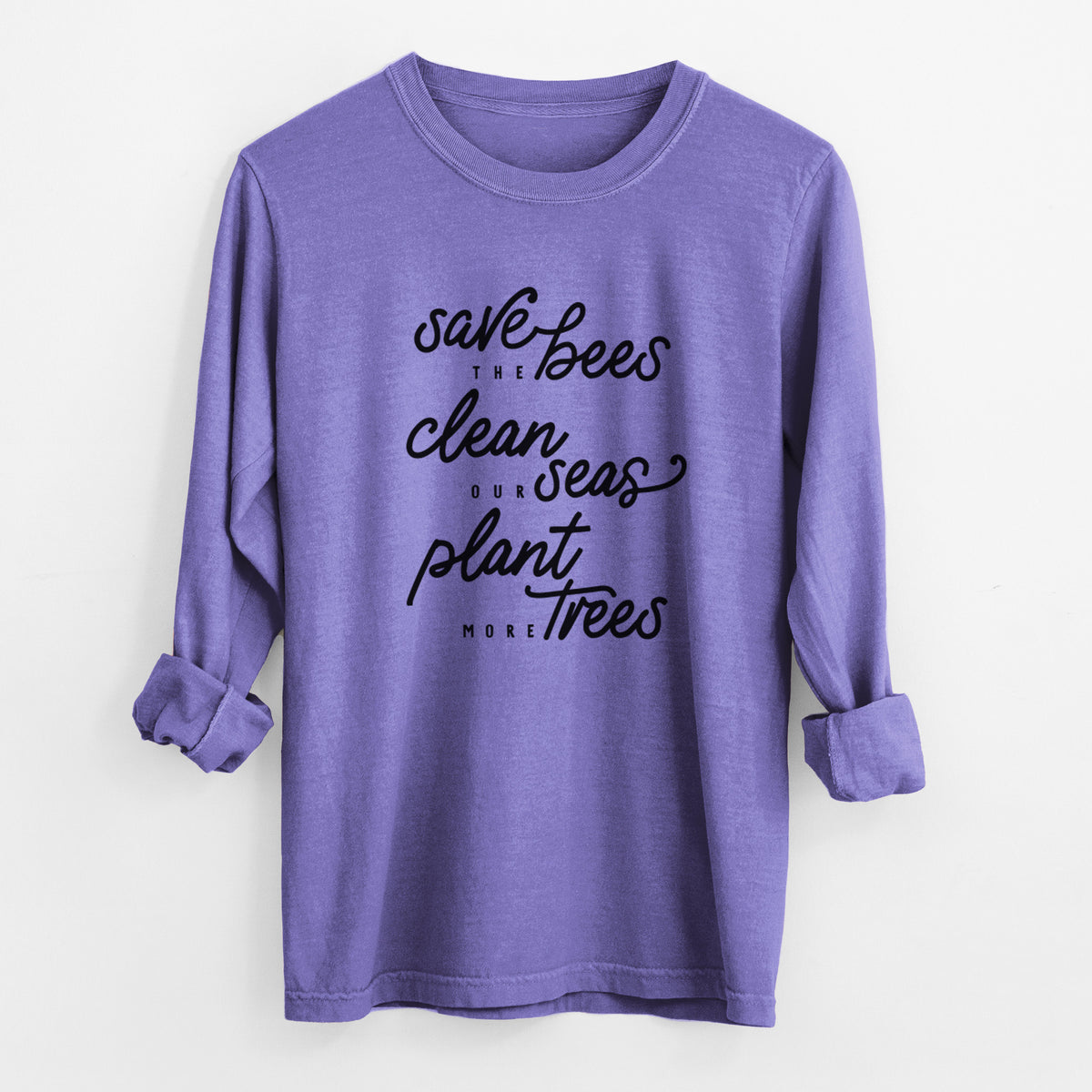 Violet purple Comfort Colors long sleeve shirt laid flat with the cuffs rolled, printed with black hand-lettered words reading Save the Bees, Clean Our Seas, Plant More Trees.