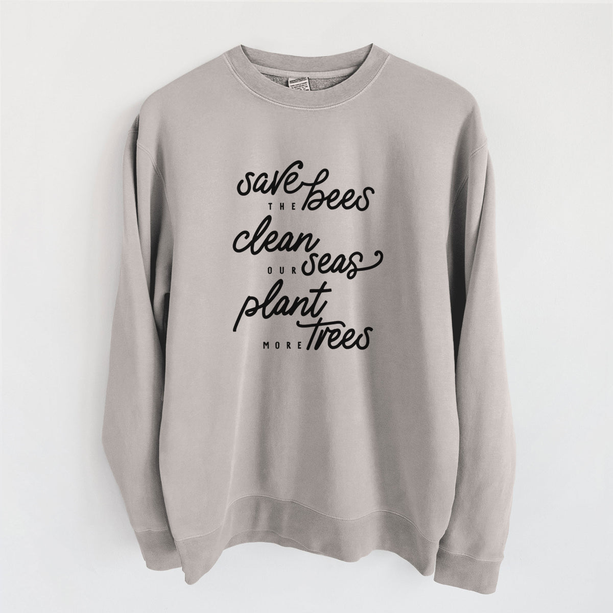Cement grey pigment dyed crewneck sweatshirt laid flat, printed with black hand-lettered words reading Save the Bees, Clean Our Seas, Plant More Trees.