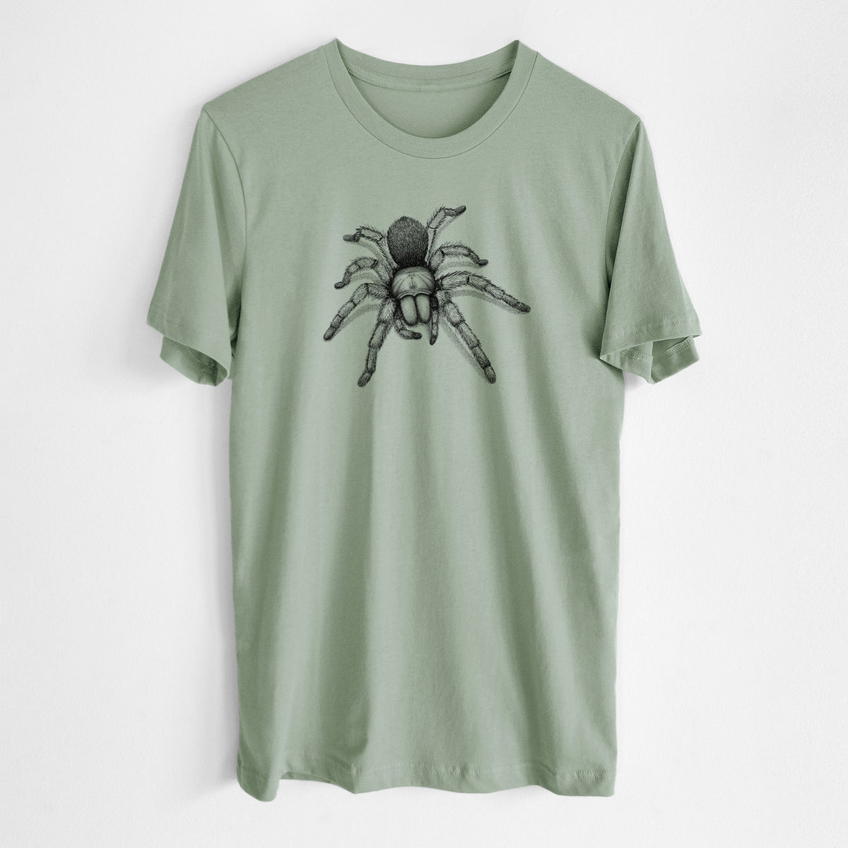 Sage green lightweight cotton t-shirt laid flat, printed with a detailed black ink illustration of a desert blonde tarantula.